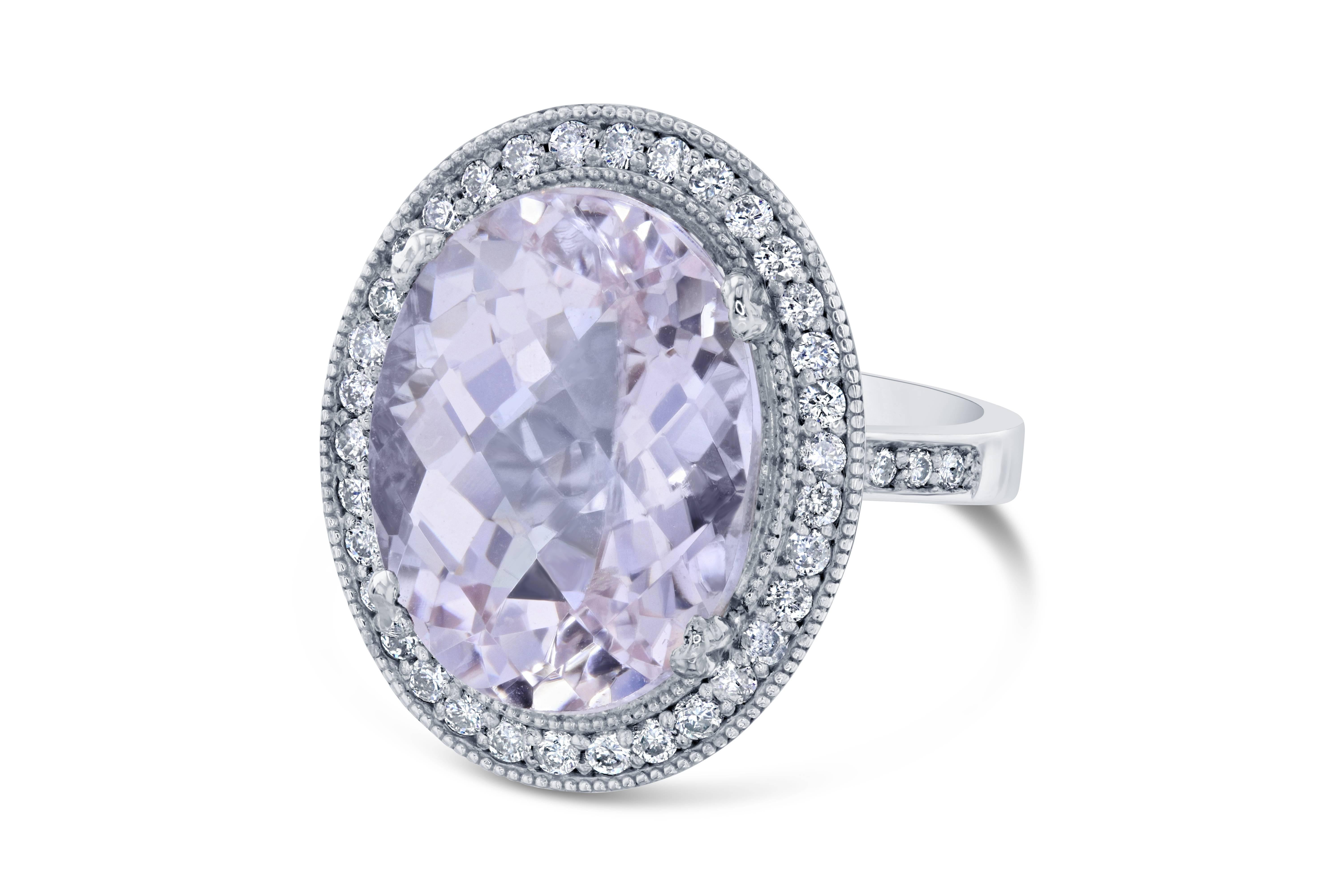 This beautiful Cocktail ring has a huge Oval Cut Kunzite that weighs 11.11 carats in the center of the ring.  The Kunzite is surrounded by 44 Round Cut Diamonds that weigh 0.52 carat. The total carat weight of the ring is 11.63 carats.  The ring is