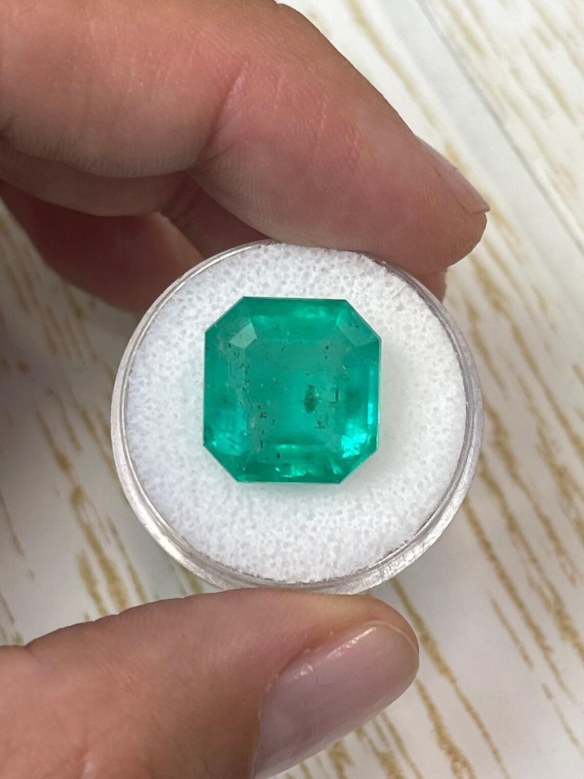 Stone: Emerald
Weight: 11.64-carats
Shape: Asscher Cut
Clarity: Transparent
Luster: Very Good
Color: Bluish Green
Measurements: 14.40mm x 13.68mm x 8.16mm
Geographic Origin: Colombia
Treatment: Natural, Oiling

Comments: Due to their growth