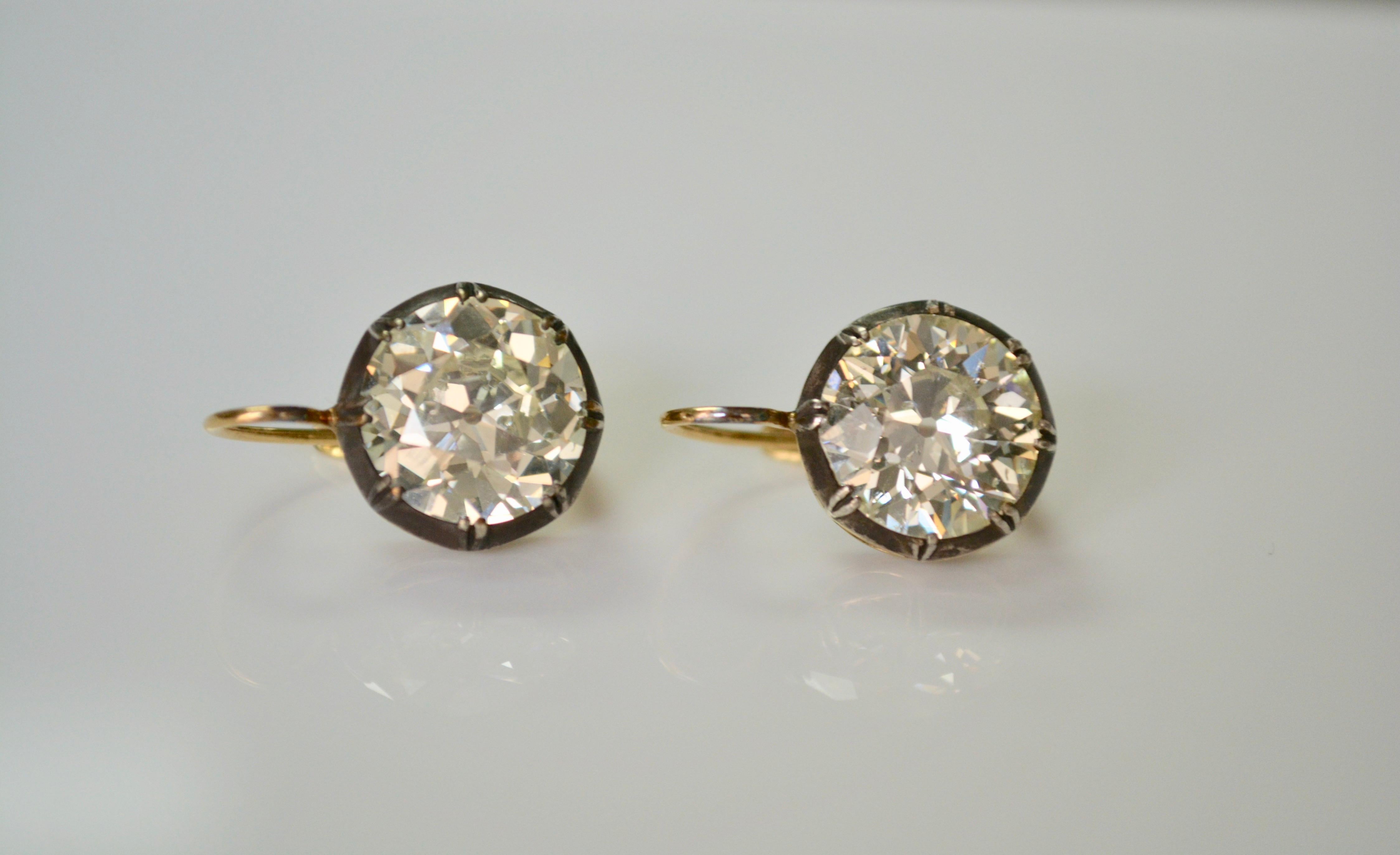 A pair of lovely antique old European cut diamond antique style dangle earrings features two large old European cut diamonds weighing 5.66 carat and 6.01 carat a total of 11.67 carat. The diamonds have L-M color and S I clarity ( eye clean). These
