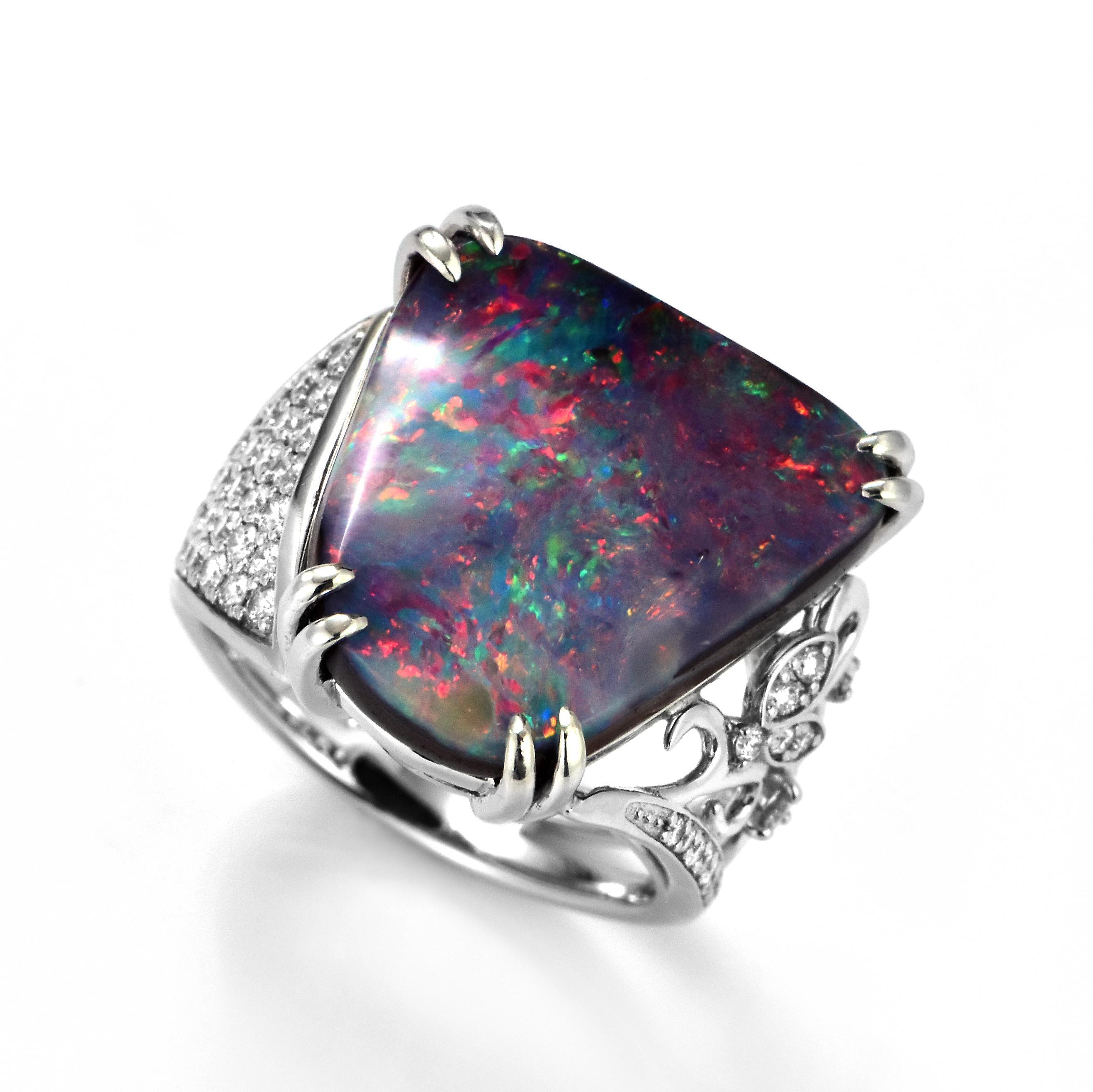 A beautiful ring featuring a 11.96 Carat, Natural, Australian Boulder Opal and 0.46 Carats of Diamond Accents set in Platinum. The Opal displays very good play of color! Opals are known for exhibiting flashes of rainbow colors known as 