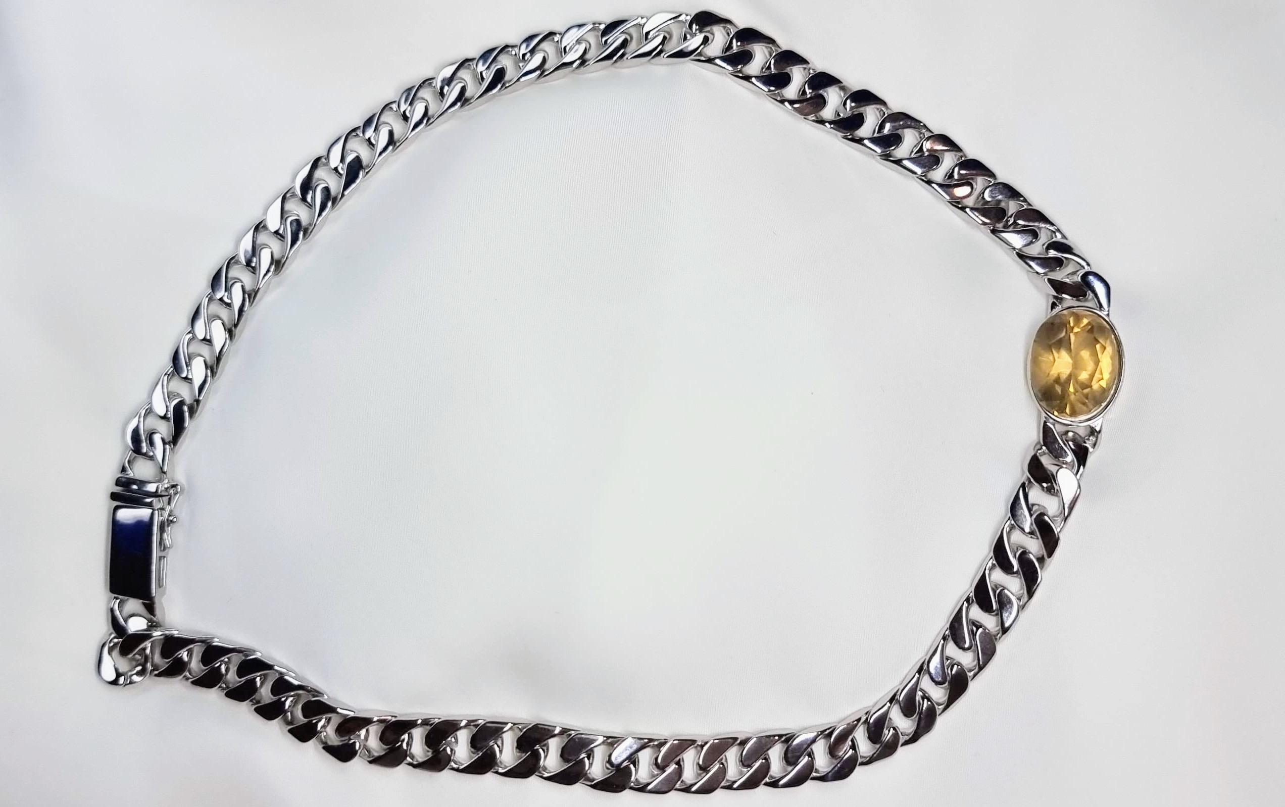 Indulge in the pure, unadulterated beauty of our 11.6 carat Natural Yellow Citrine Sterling Silver Curb-Link Necklace. This exquisite gemstone, measuring an impressive 16.1mm x 12.6mm x 10.2mm, is a testament to the earth's natural wonders. 

Unlike