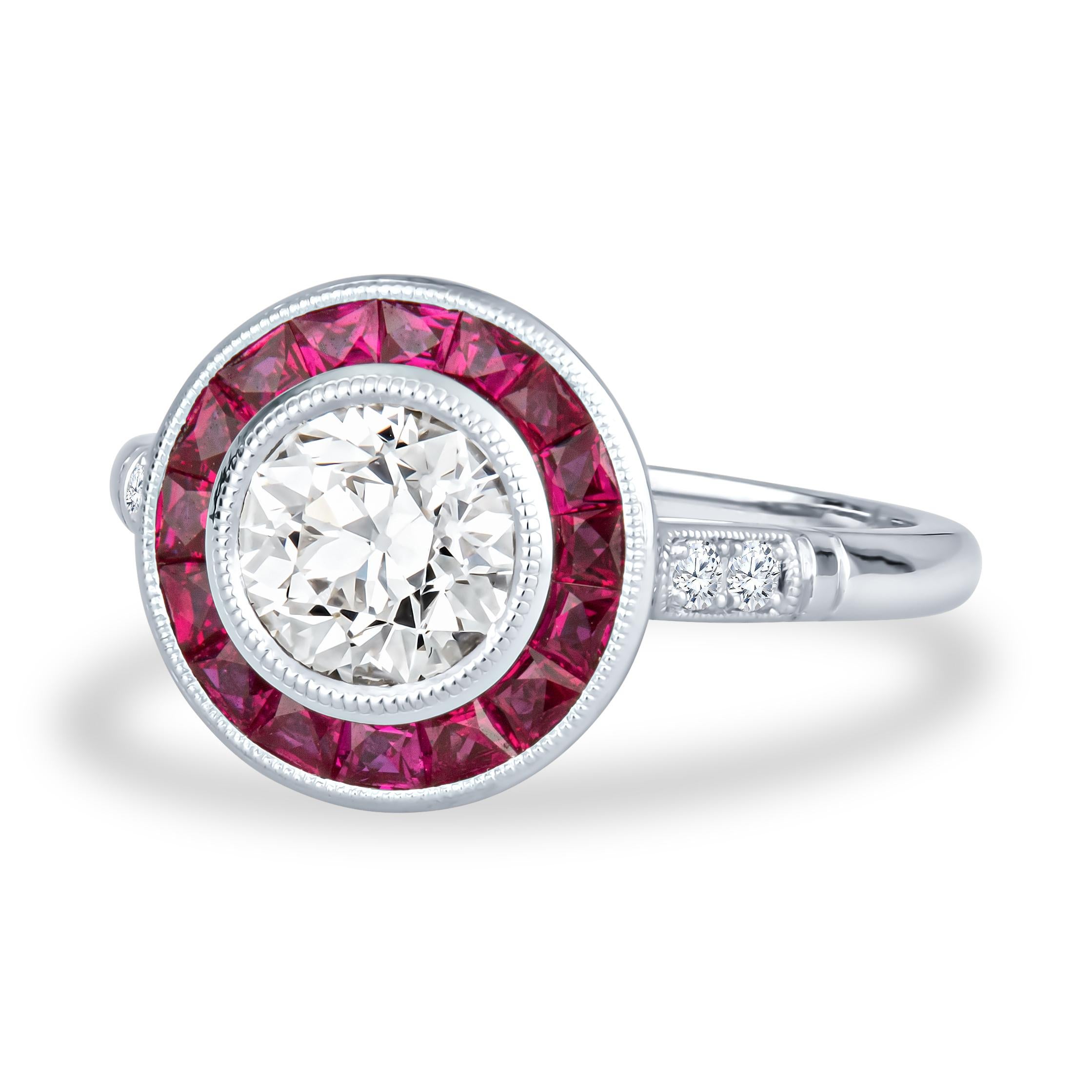 This exquisite, unique Shaftel Diamonds engagement ring features a 1.16ct Old European cut diamond (M VS2), surrounded by a beautiful halo of 0.75ct total weight in rubies and 0.07ct total weight in accent diamonds. The ring itself is 18kt white