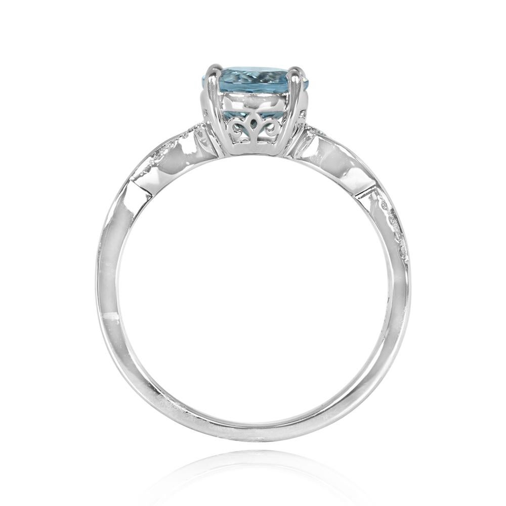 A stunning round cut 1.16-carat natural aquamarine gemstone ring. The center stone is prong-set and features an openwork under-gallery. The shank boasts a twist design adorned with round brilliant cut diamonds set in a micro-pave style. Hand-crafted