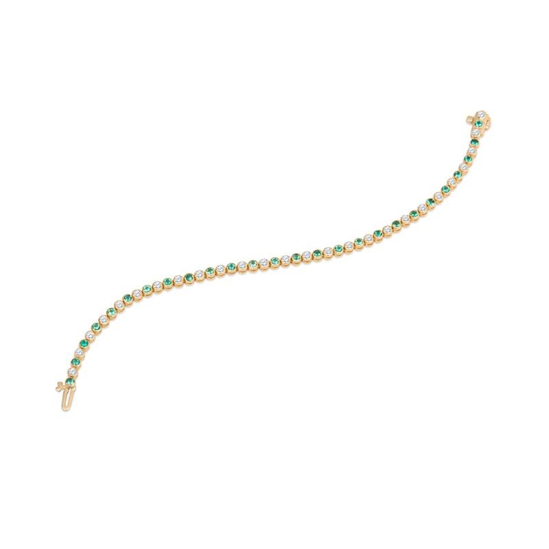 This bracelet features 1.16 carat total weight in round natural emeralds alternating with 1.32 carat total weight in round natural diamonds that are bezel set in 14 karat yellow gold.  Wear this everyday, layer with your other favorite bracelets, or