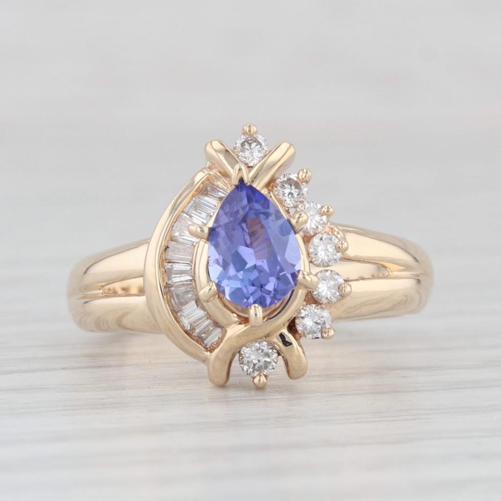 Gemstone Information:
- Natural Tanzanite -
Carats - 0.78ct 
Cut - Pear Brilliant
Color - Purple
Treatment - Heated
Please note there is a small chip to the tanzanite.

- Natural Diamonds -
Total Carats - 0.19ctw
Cut - Round Brilliant
Color - F -