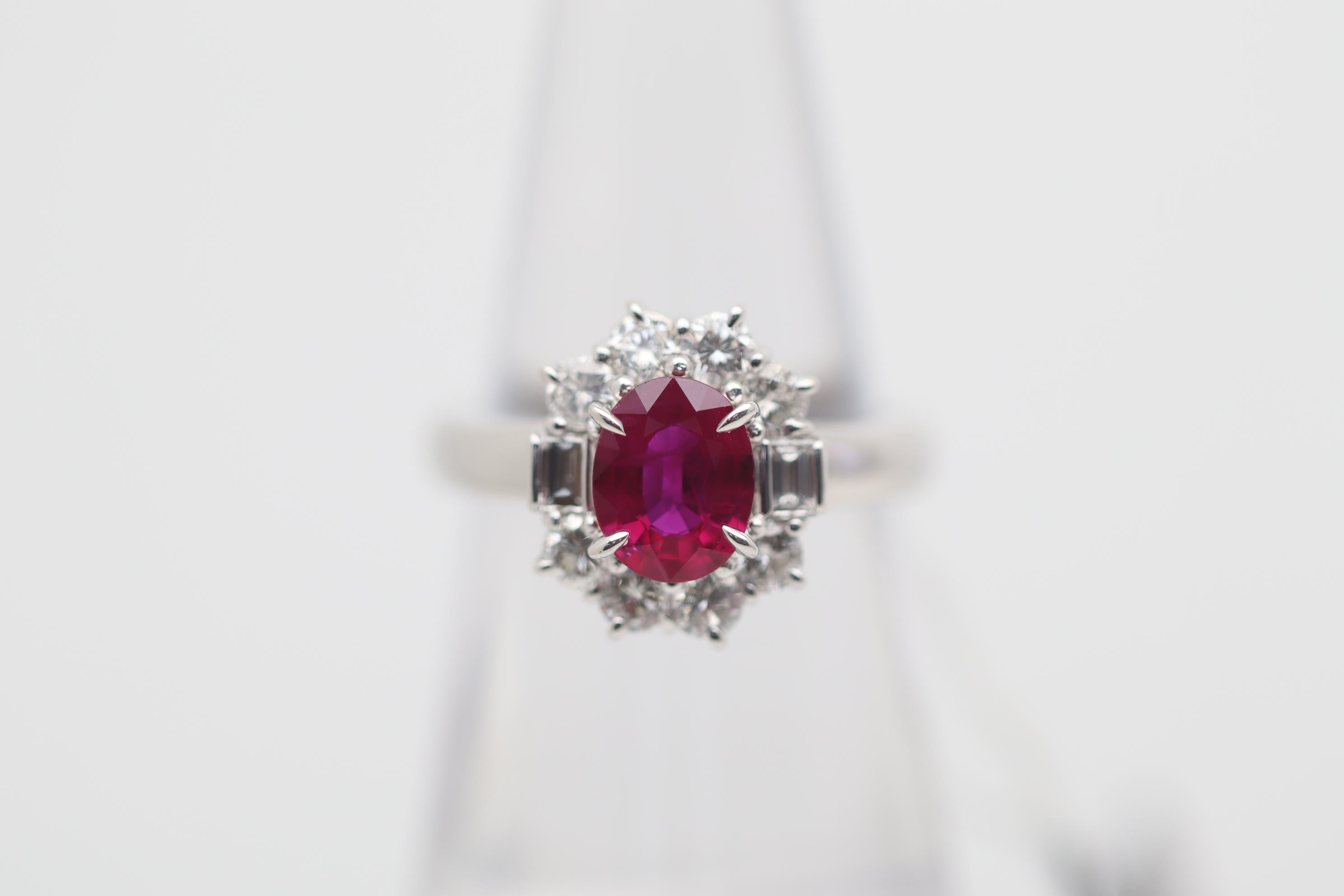 A chic and classy gemstone diamond ring featuring a fine natural Burmese ruby. The ruby weighs 1.17 carats and has a bright and vibrant cherry-red color, a classic Burmese color. It is complemented by 0.89 carats of diamonds set around the ruby in a