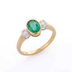 1.17 Ct Bezel Set Oval Emerald and Diamond in 18K Yellow Gold Three Stone Ring
