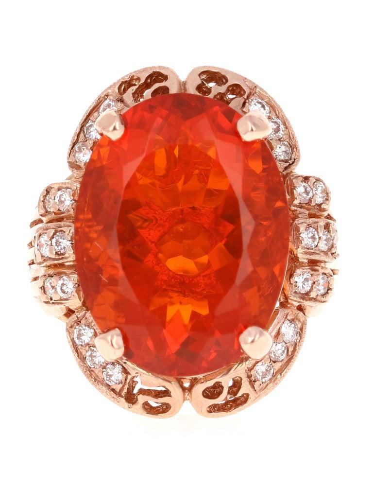 Bold, Beautiful and Bright Orange Fire Opal Cocktail Ring!

This ring has a stunning 11.29 Carat Oval Cut Fire Opal in the center of the ring and is surrounded by 26 Round Brilliant Cut Diamonds that weigh a total of 0.42 Carats. The total carat
