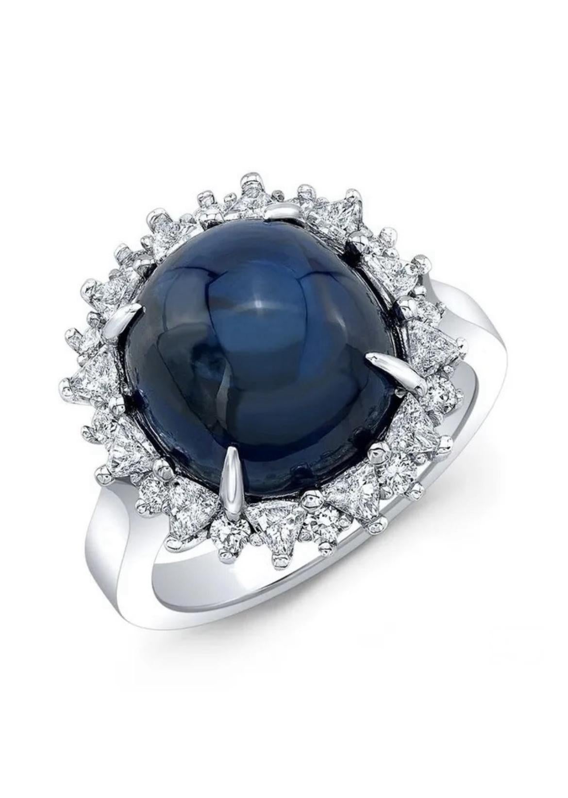 An alluring 11.72-carat, cabochon blue sapphire from Sri Lanka is centered upon this intricate platinum ring. 

Supported by 24 glittering trillion-cut and round white diamonds weighing 0.67 carats, it's a drop of the night sky encircled by