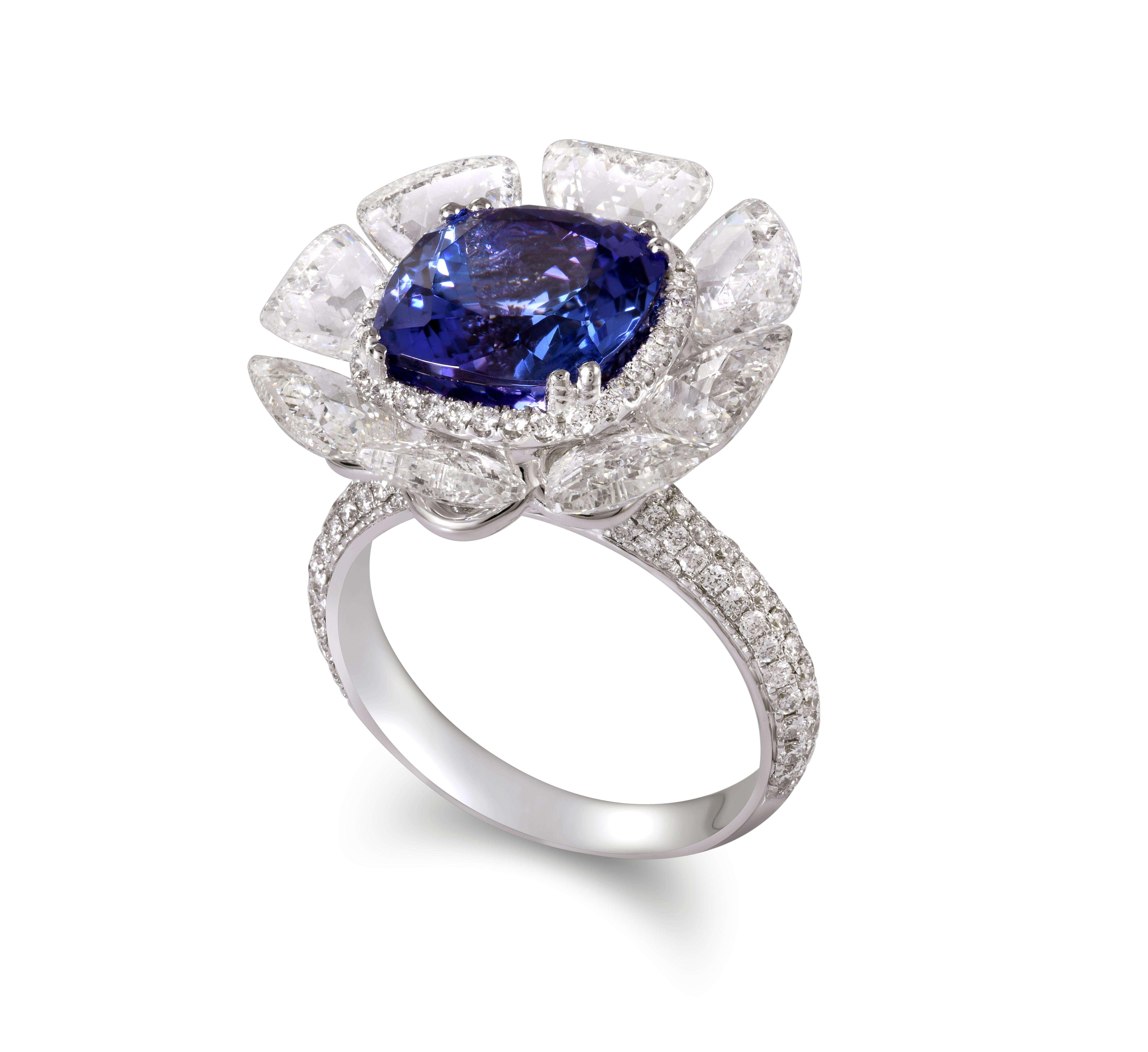 This vibrant ring is a perfect example of Rarever's artistry. The vivid purplish-blue 5.29ct tanzanite is framed by a halo of striking Tawiz cut diamonds that have a gentle movement to them. The minimal use of metal accentuates the natural fire in