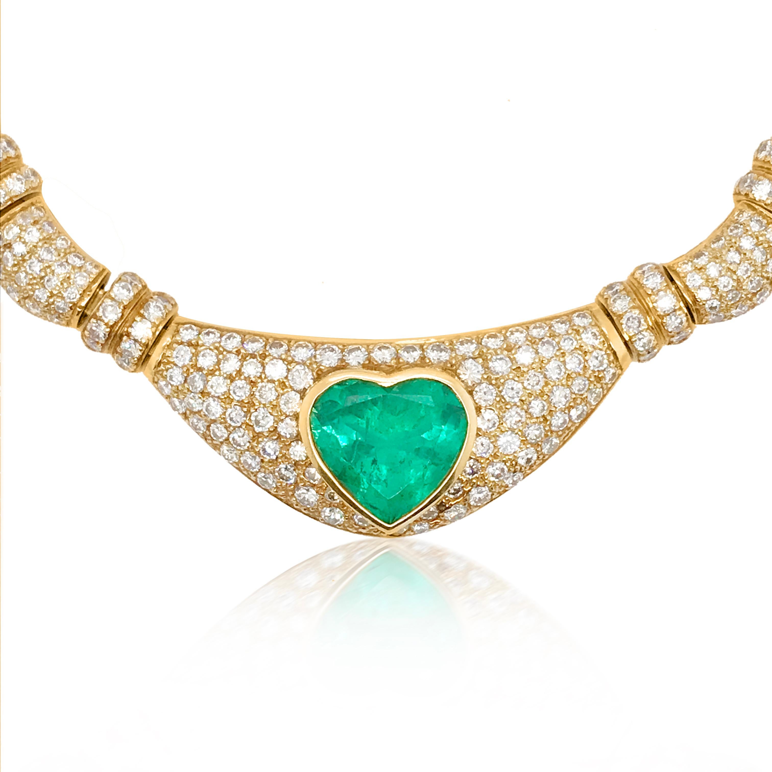 This gorgeous and alluring emerald and diamond necklace is crafted in 18K yellow gold, weighing 77.5 grams and center panel measuring 20.6x50.8mm (13/16 x 2 inches). It is centered with one heart-shaped genuine emerald weighing approx. 11.75 cts,