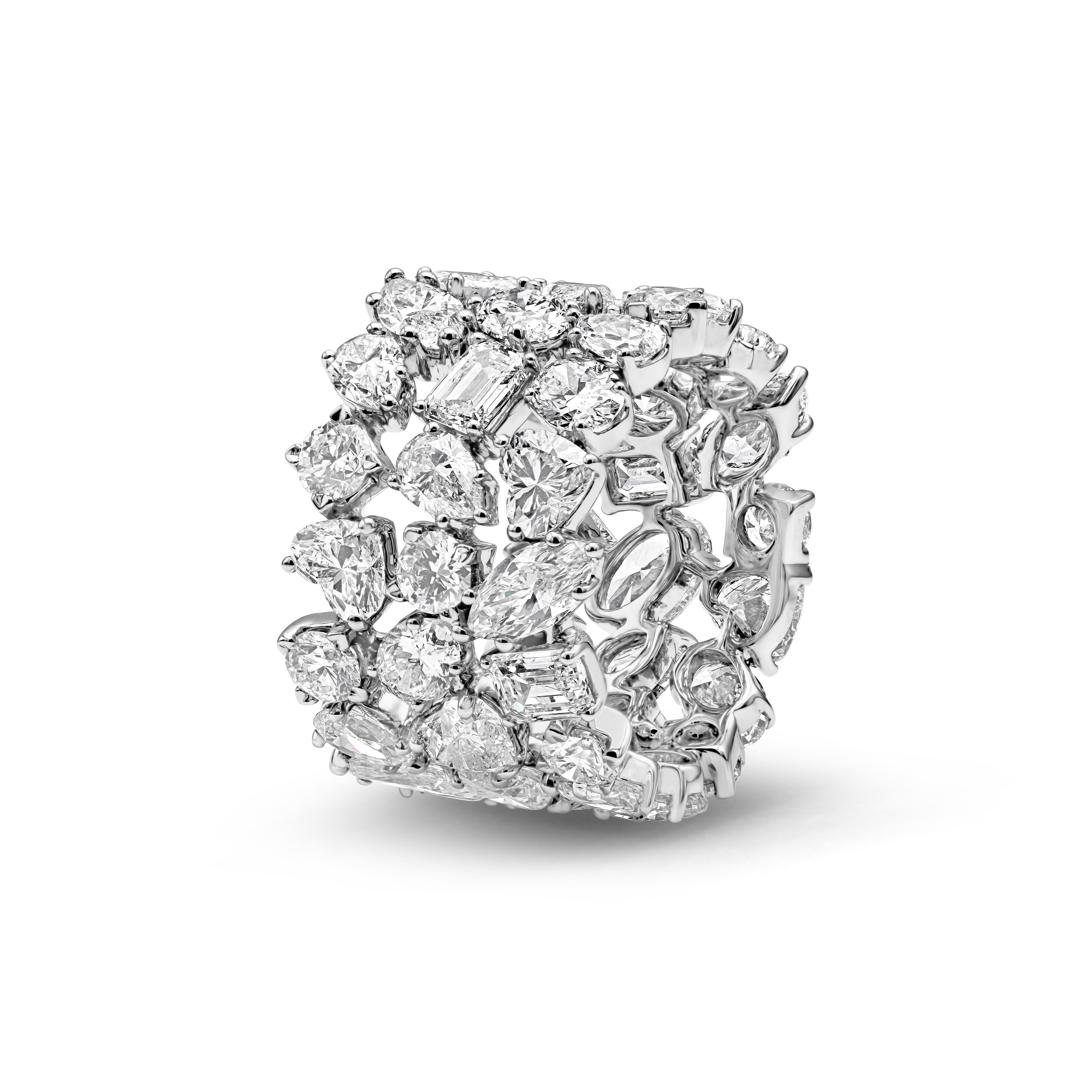 This unique and well crafted piece of jewelry showcasing a magnificent three-rows of mixed fancy cut diamonds set in an open-work, floating diamond design that consist of marquise, oval, brilliant round, heart shape and emerald cut made in 18 karat
