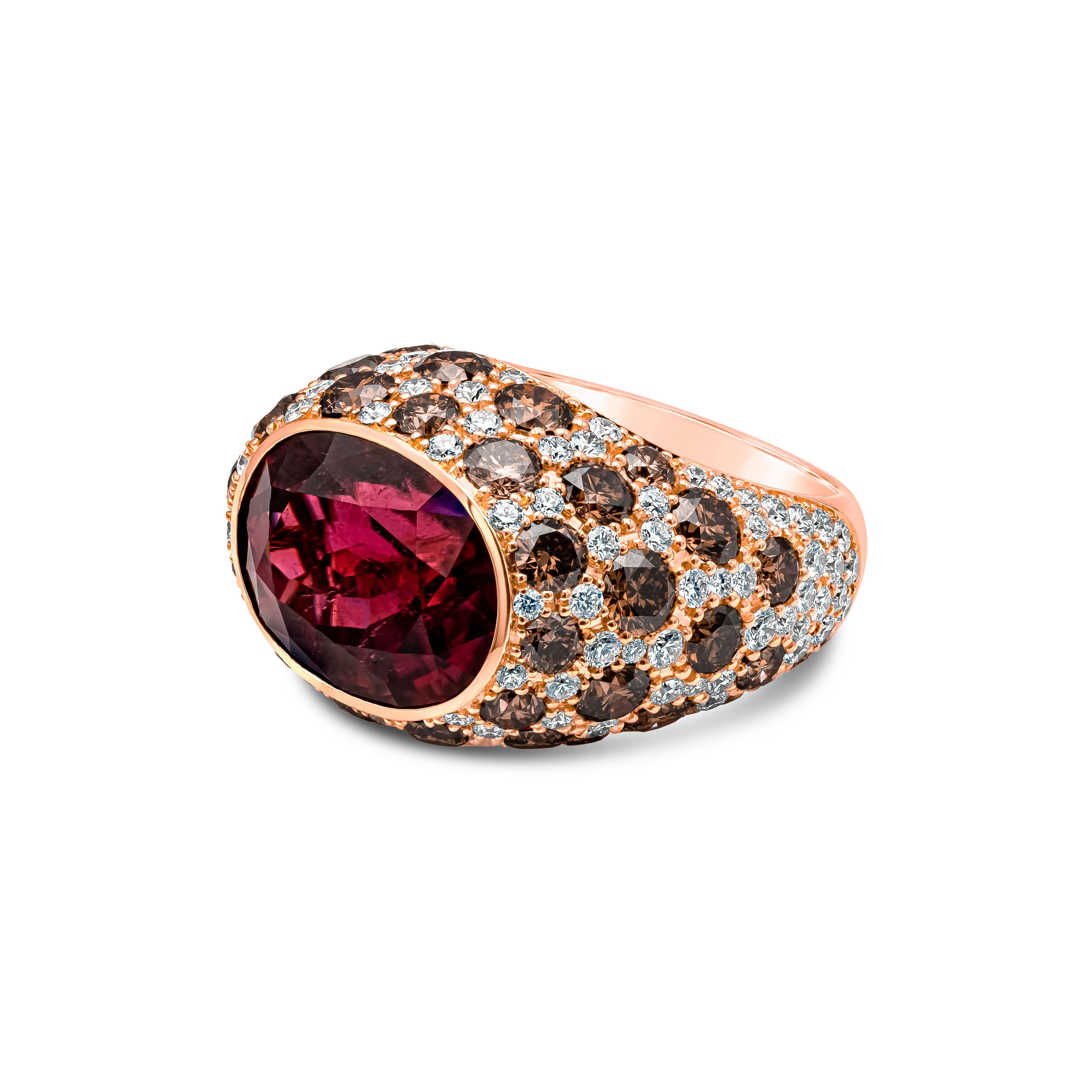 An intriguing and conversation piece of fashion ring showcasing a oval cut rubellite tourmaline weighing 11.79 carat, Bezel set. Accented with round pave set brown and white diamonds, Brown diamonds weighs 5.62 carats, VS in Clarity, and White