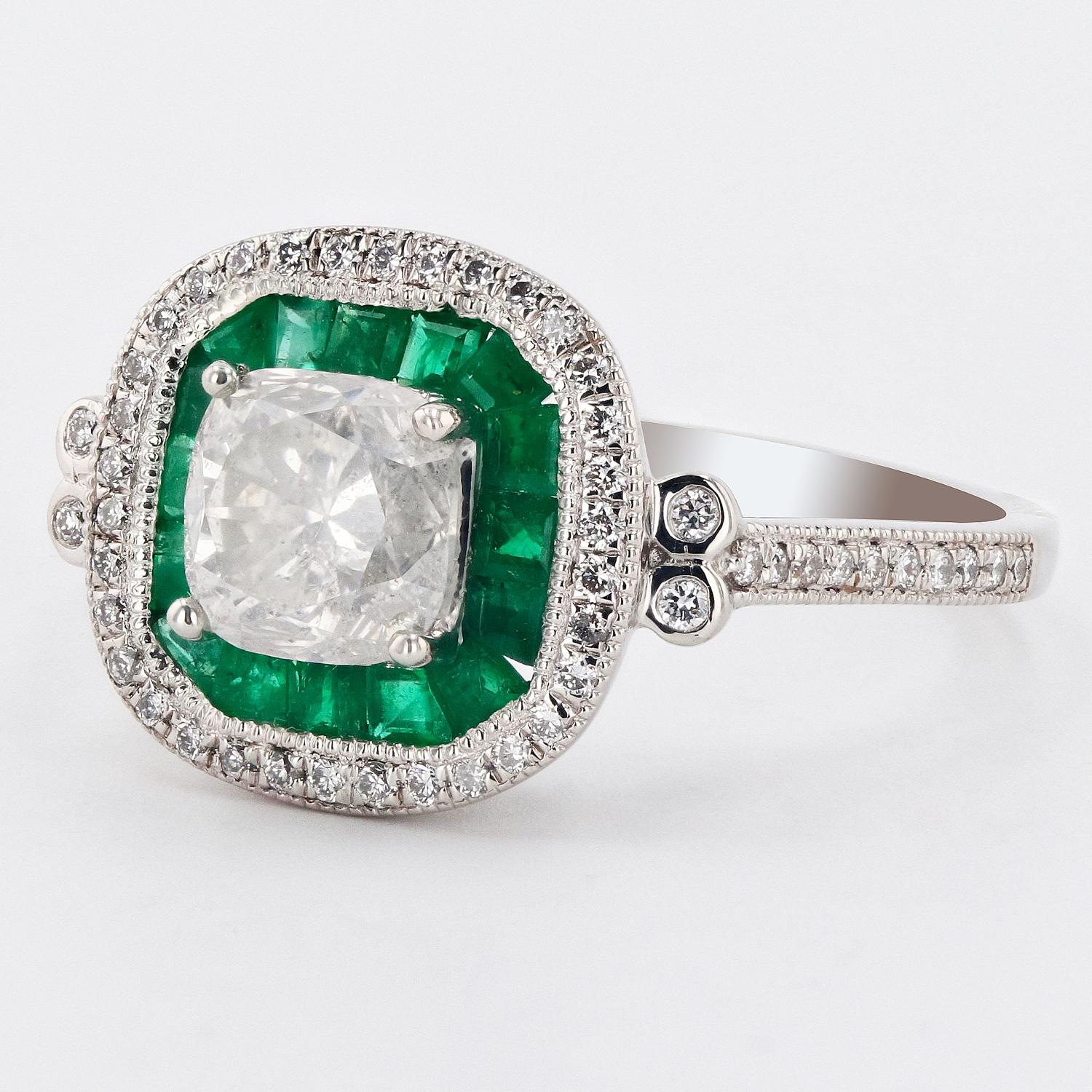 One electronically tested platinum ladies cast & assembled diamond & emerald ring. 

The featured diamond is set within an inner emerald bezel and and outer diamond bezel, supported by a lattice under gallery and diamond set shoulders, completed by
