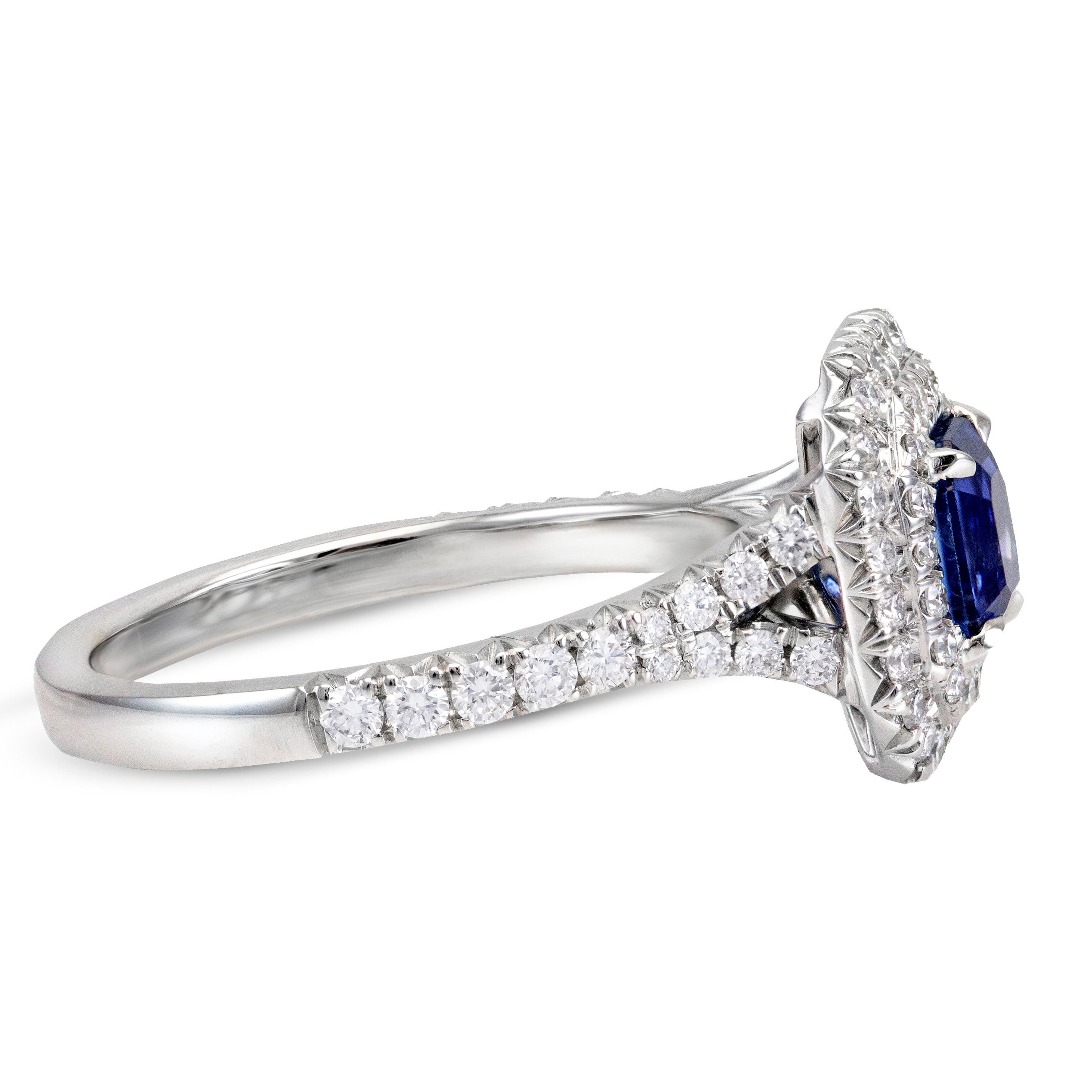 Features a beautiful 1.18 carat blue sapphire at the center. Framed by 2 rows of brilliant round diamonds. Diamonds also set half way all over the shank of ring. Weight of the diamonds is 0.70 carats. Made in 18k white gold. Size 6 US