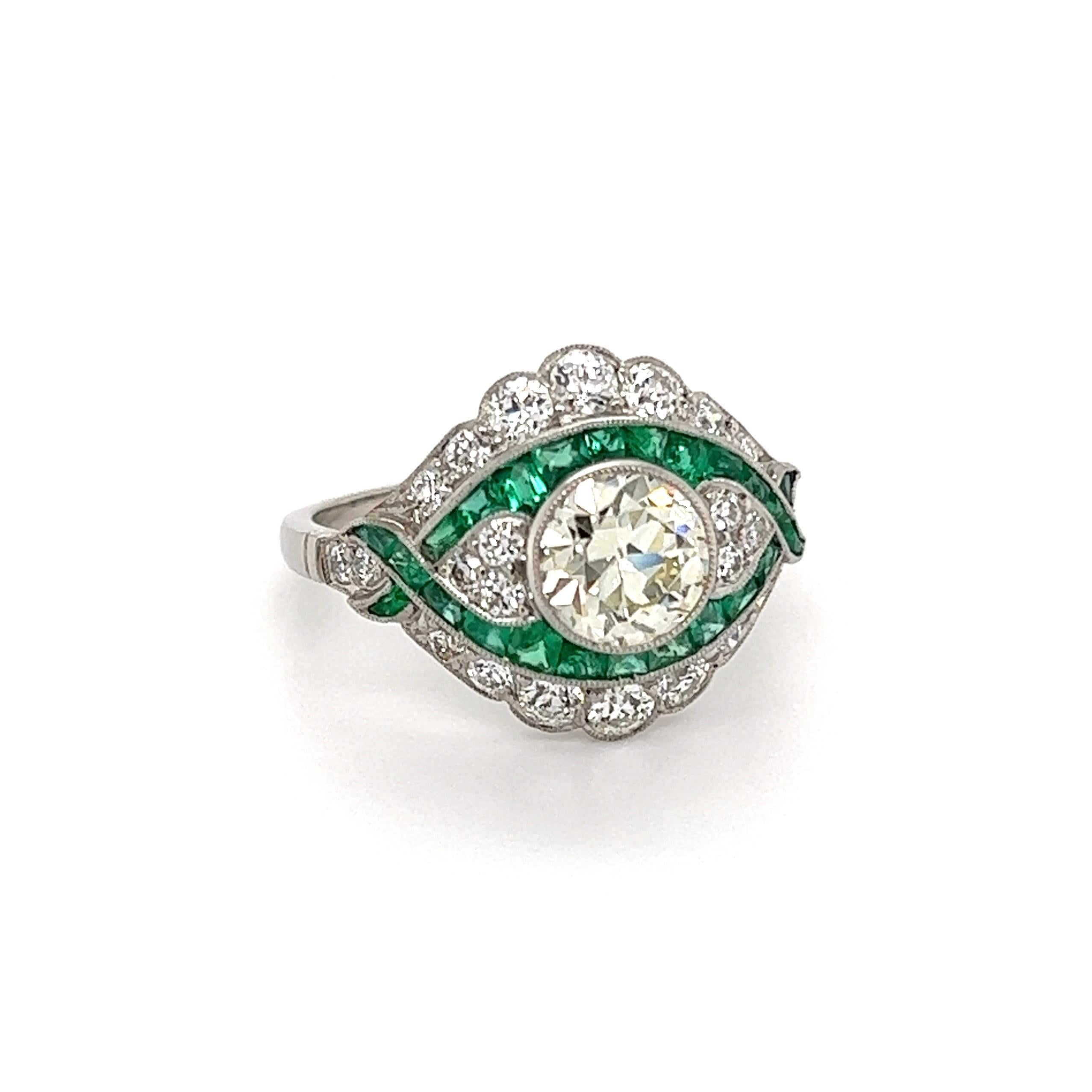 Simply Beautiful! Finely detailed Art Deco Revival Diamond and Emerald Cocktail Ring. Centering a securely nestled Hand set 1.18 Carat Old European-Cut Diamond, artistically surrounded by 24 Custom-Cut Emeralds, weighing approx. 0.97tcw and 24