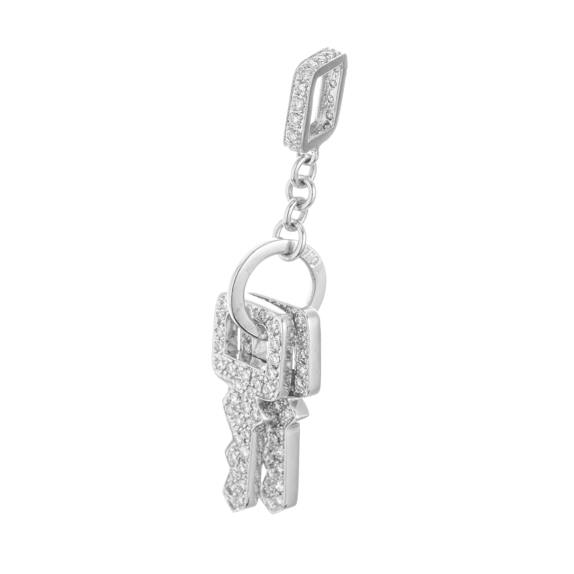 Unlock the allure of elegance with our 1.18ct pave Diamond and white gold Keys pendant. Crafted with precision, this exquisite piece features a dazzling array of 164 pave set diamonds, each gem meticulously selected to enhance its radiant sparkle.