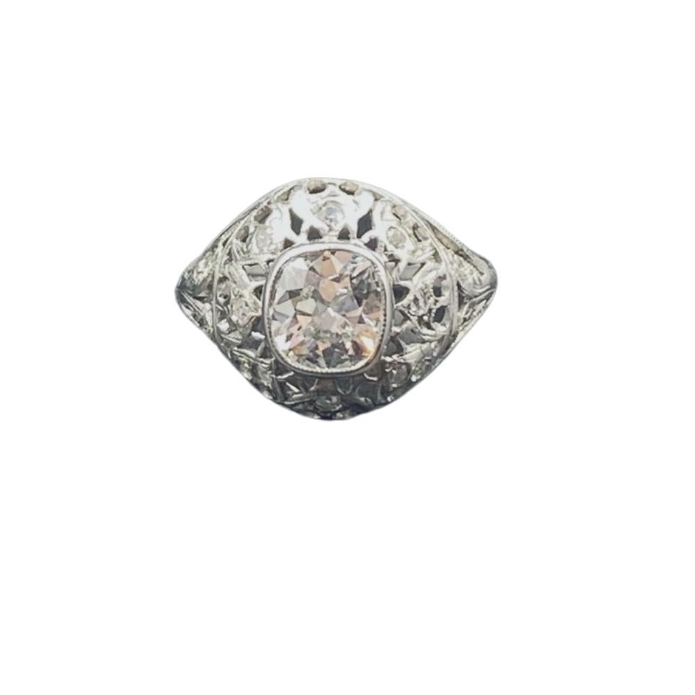 Edwardian era old miner cut diamond, centered in an antique platinum mount, displaying extensive airy lace work and nature inspired engravings.

 Shape	Old