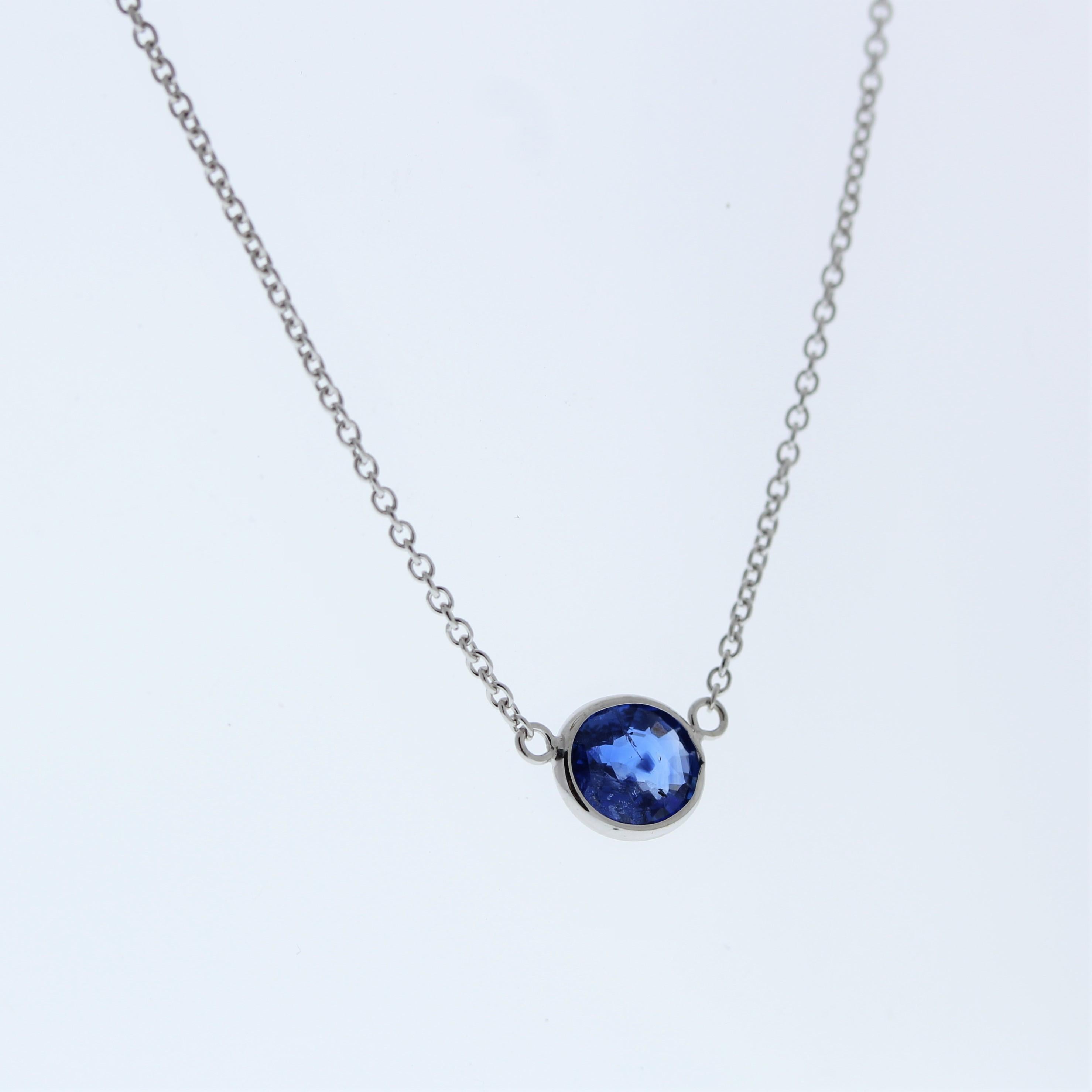 The necklace features a 1.18-carat oval-cut blue sapphire set in a 14 karat white gold pendant or setting. The oval cut and the blue sapphire's color against the white gold setting are likely to create an elegant and versatile fashion piece that