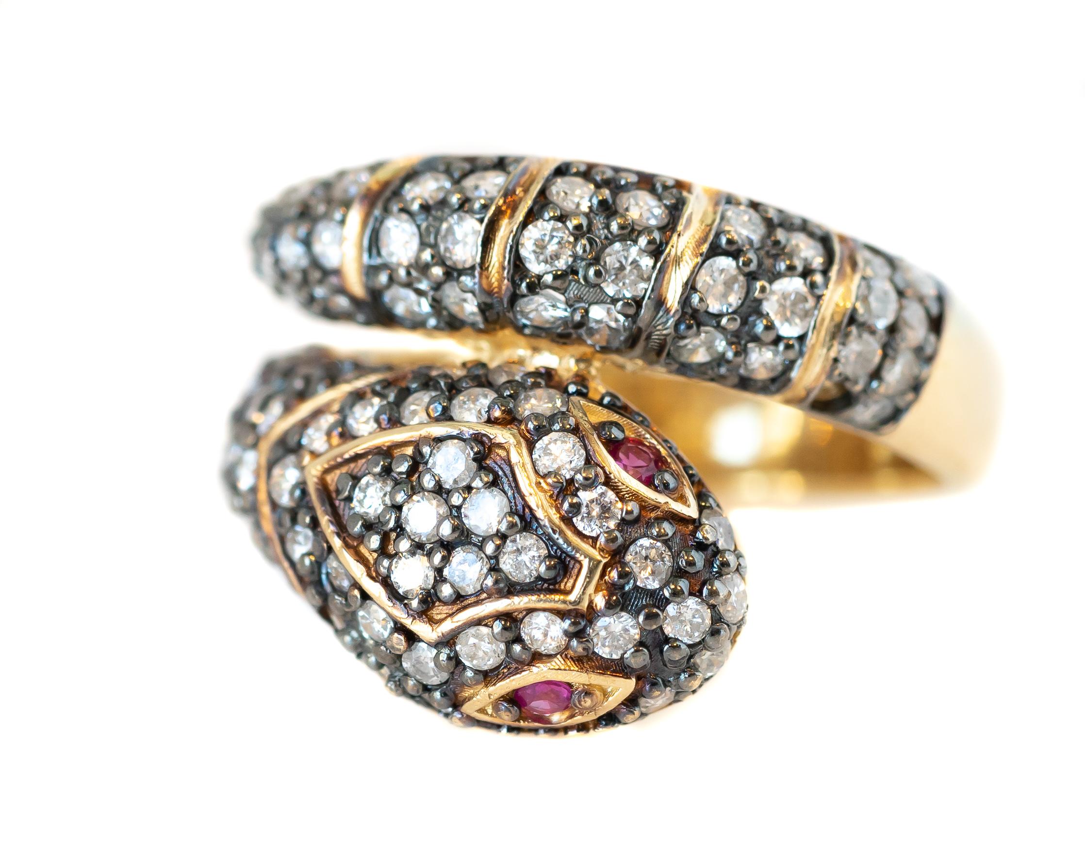 Diamond Snake Serpent Ring crafted in 14 karat Yellow Gold with Diamonds and Pink Sapphires

Features:
1.18 carat total Round Brilliant Diamonds
.04 carat total Pink Sapphires (total count 2)
14 karat Yellow Gold
2 Coil Gem Encrusted front 
Smooth