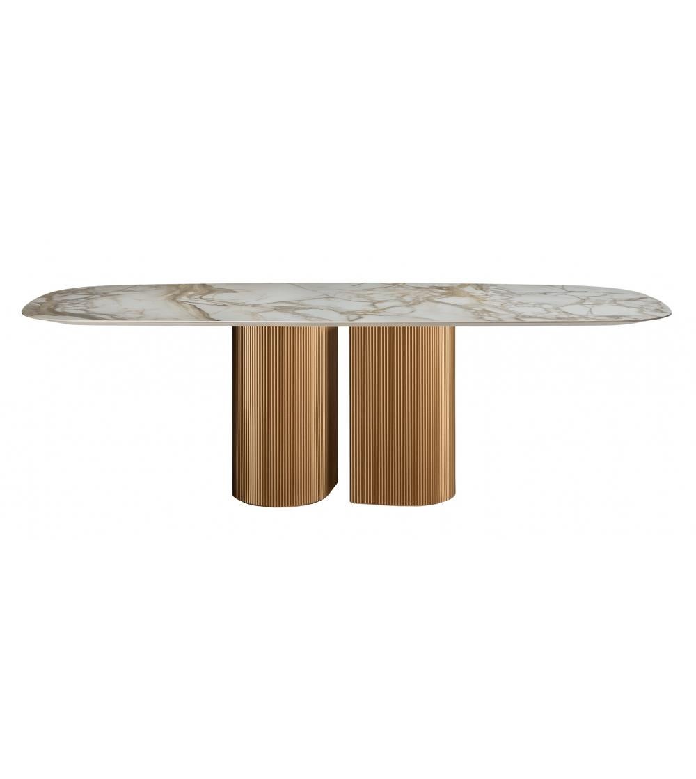 Contemporary dining table featuring lacquered metal base with stripes. 
Shaped soap ceramic top, in white Calacatta finish.
Marble top available upon request in variety of finishes. 
Ceramic top is also avavailable in grey, black, green, brown,