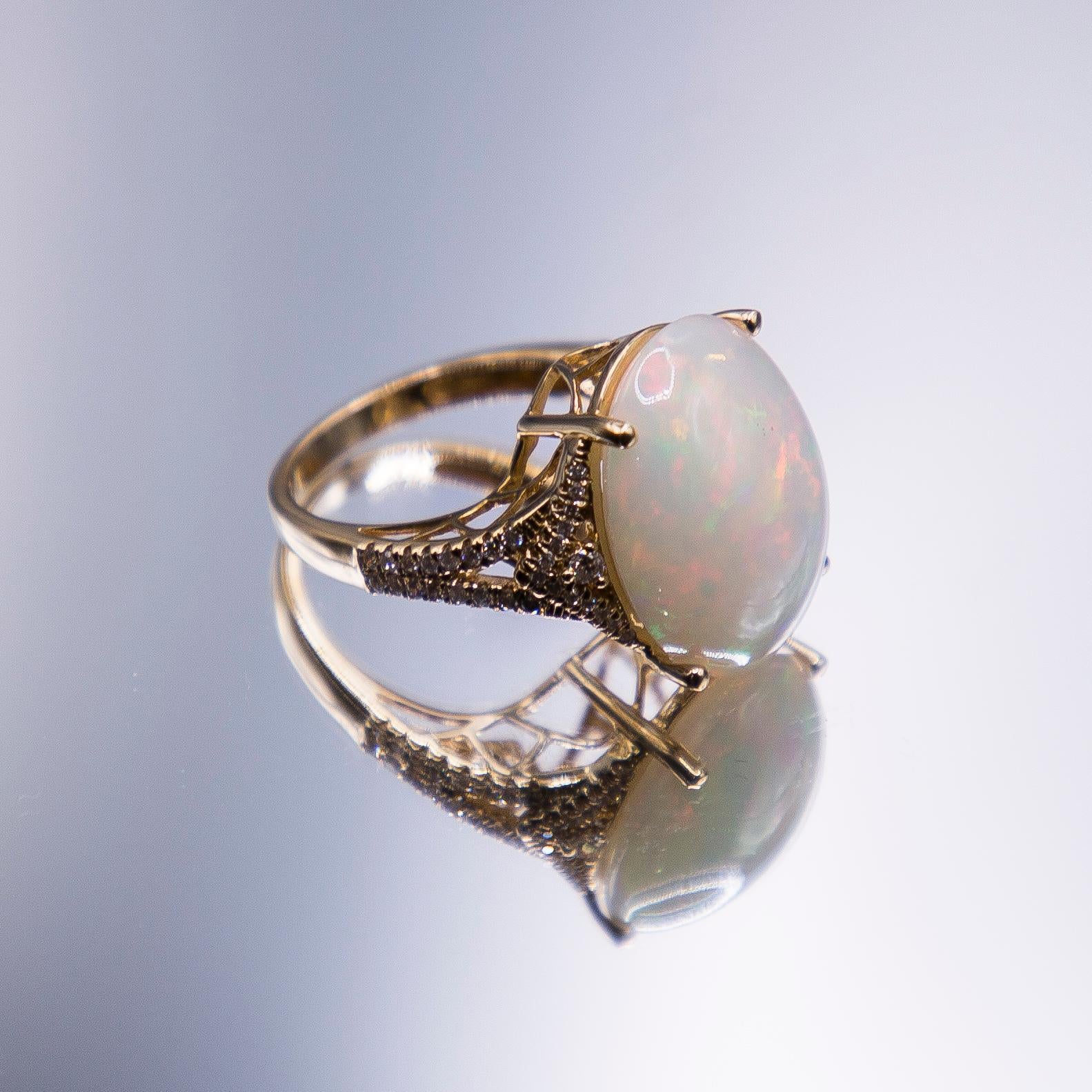 Unrivaled, this heart stopping  11.83 carat Crystal Opal from Lightning Ridge Australia, is amongst the most intriguing and mysterious of the designer's 5-decades career.  The lovely cab radiates predominantly harlequin flashes of hot reds and