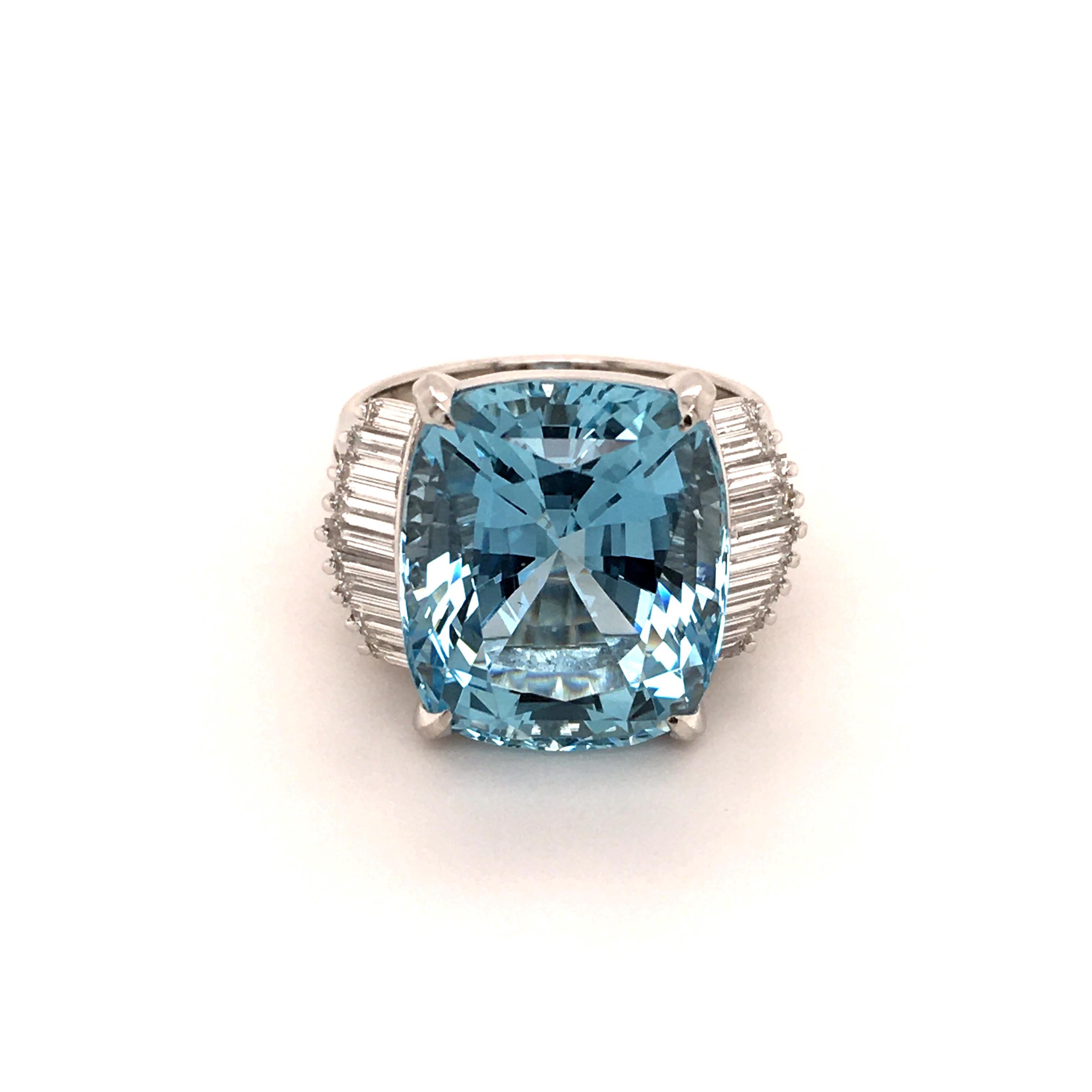 A superbly cut 11.89 carats Aquamarine adorns this ring in 900 Platinum. The cushion shaped center stone is flanked by 18 baguette shaped diamonds of G/H color and vs clarity, total weight 0.83 carats.

Size: 53.5 (EU) / 6.75 (US)
Engraving: 11.89