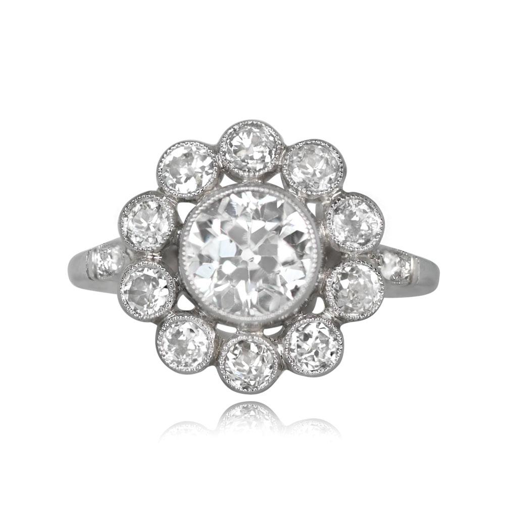 A stunning diamond cluster ring features a center old European cut diamond, 1.18 carats, securely bezel-set. The center stone is elegantly encircled by a floral halo of bezel-set old mine-cut diamonds. Further enhancing the piece, single-cut