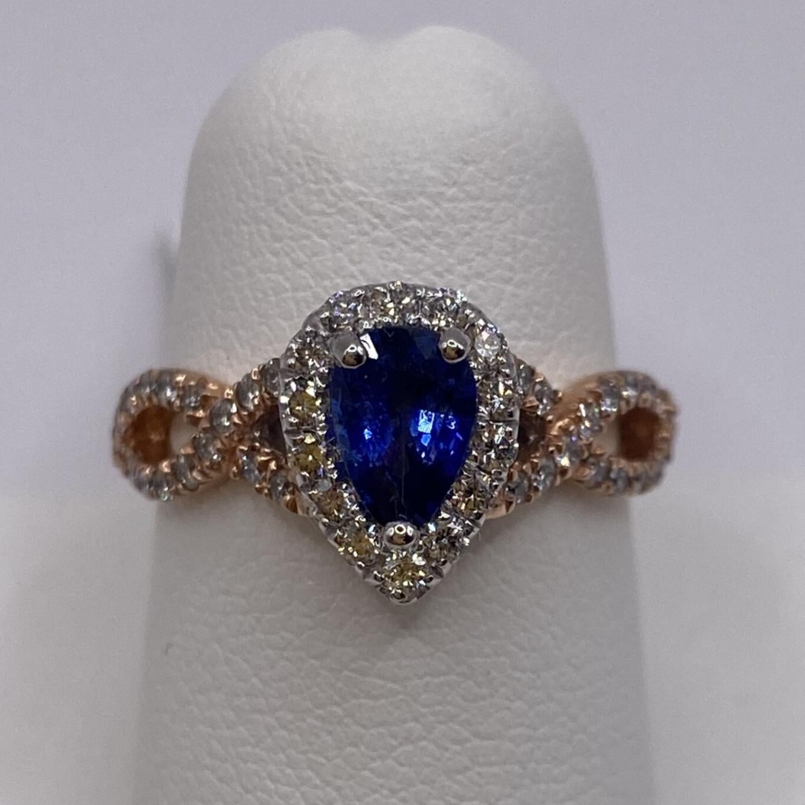 14KT White & Rose Gold
Finger Size: 6.5

Number of Pear Shape Sapphires: 1
Carat Weight: 0.72ct
Stone Size: 7.0 x 4.5mm

Number of Round Diamonds: 46
Carat Weight: 0.46ctw

A .72ct pear shape bright blue sapphire is framed by a pave set halo