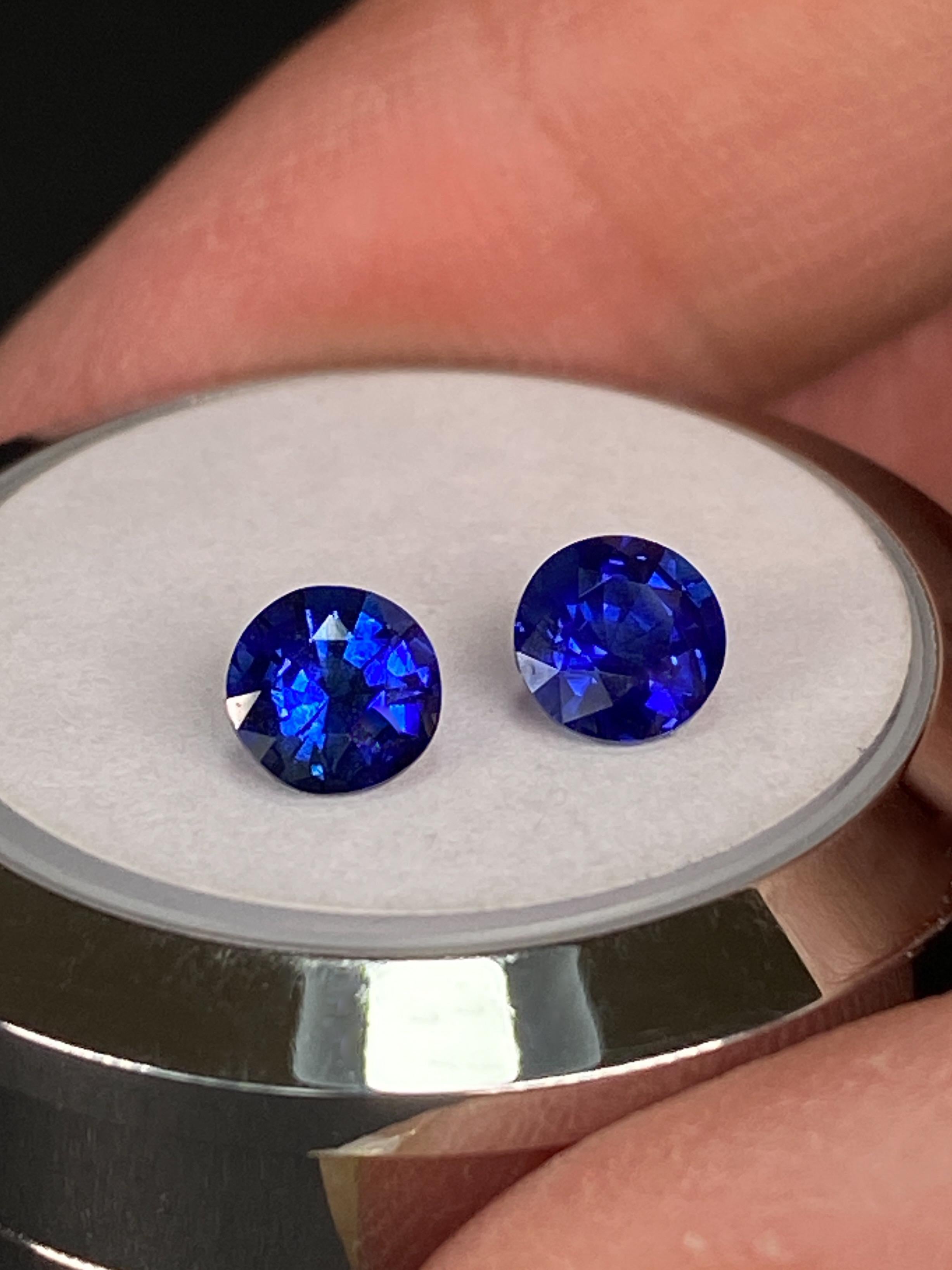 The Sapphire Merchant presents this captivating 1.18ct Natural Royal Blue Sapphire Pair to 1stDibs. Each gemstone weighs approx 0.59 carats, presenting a harmonious symmetry in round shapes. Their round brilliant cut enhances their brilliance and