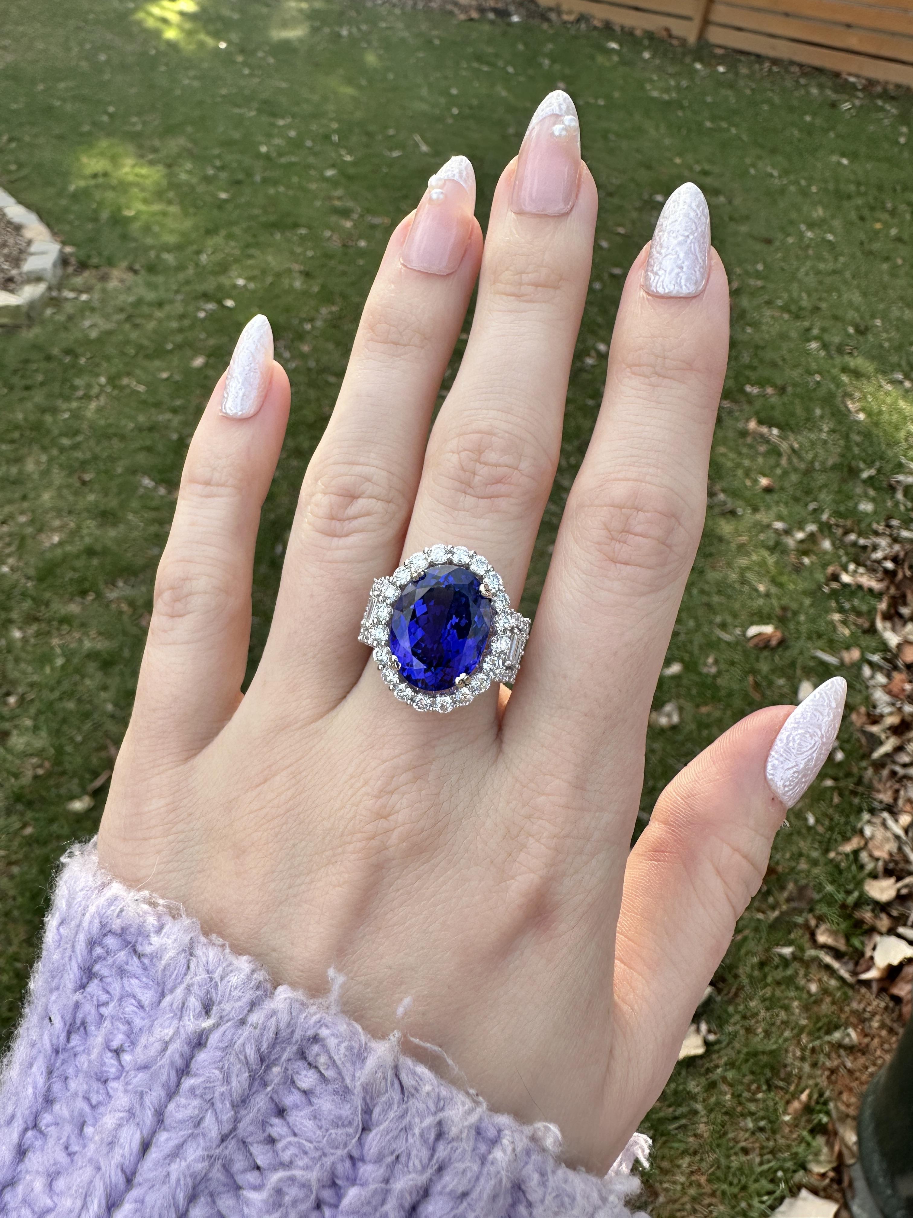 This beautiful statement ring features a 11.81 carat oval 16x12mm Tanzanite gemstone with a halo of natural earth mined diamonds set in solid 14K white gold. This Tanzanite ring makes a lovely December birthstone gift for your loved ones!

**We