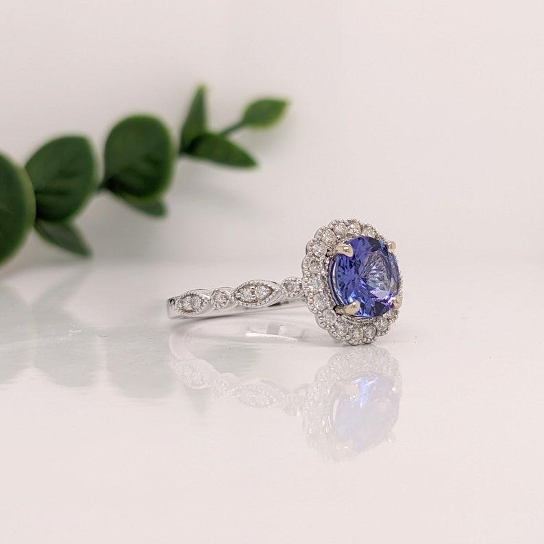 This statement ring features a vibrant Tanzanite in 14K White Gold with a natural Diamond halo and beautiful Milgrain detailing. This collection ring makes for a stunning accessory to any look!

A fancy ring design perfect for an eye catching