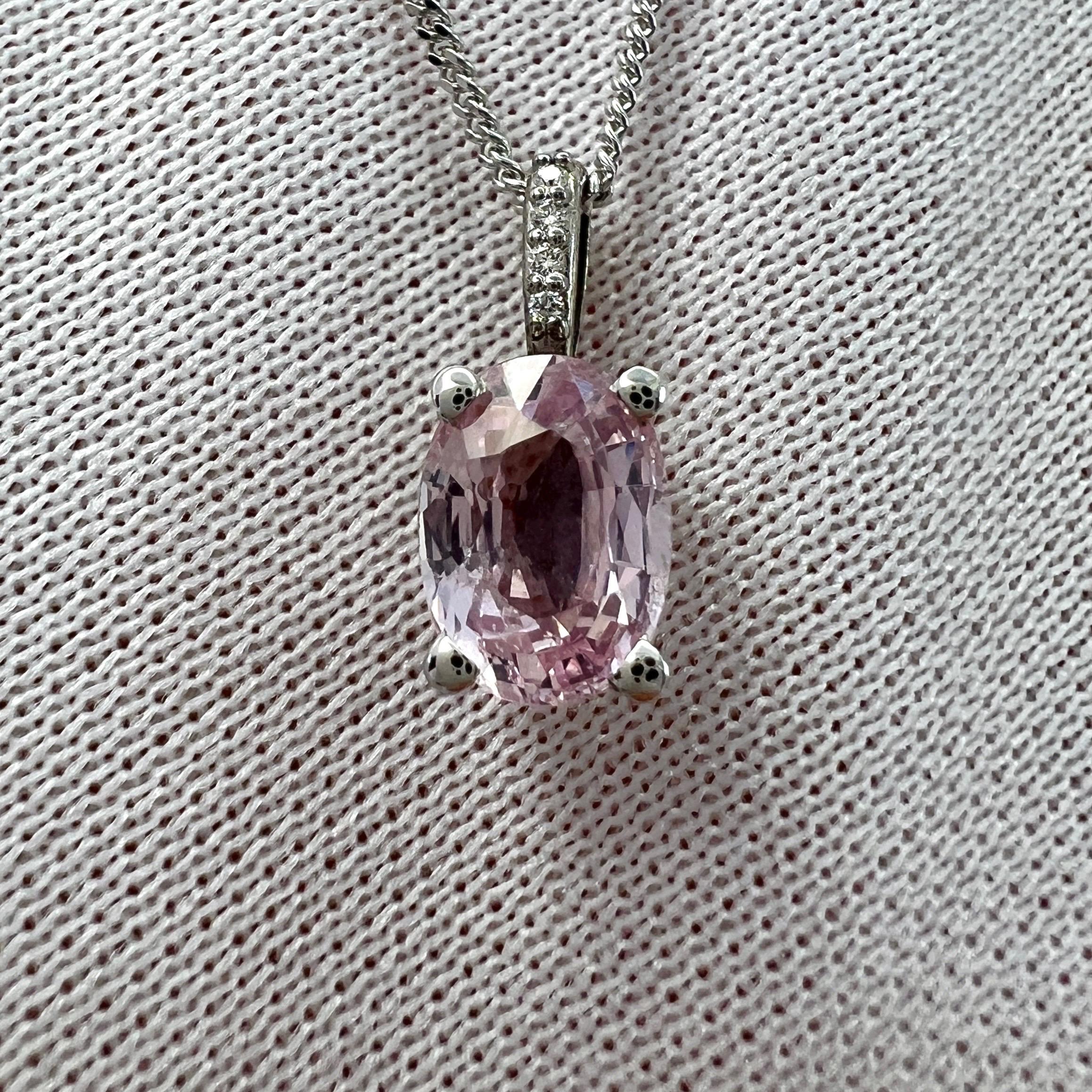 Natural Vivid Light Pink Sapphire & Diamond 18k White Gold Hidden Halo Pendant Necklace.

1.18  Carat sapphire with a vivid light colour and good clarity. A clean stone with only some small natural inclusions visible when looking closely.
Also with