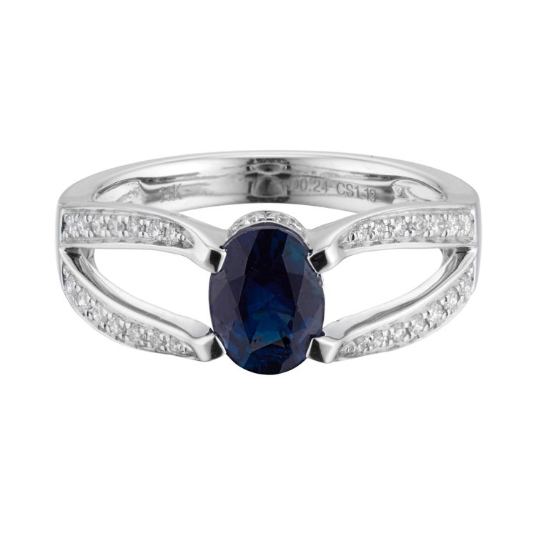 Sapphire and diamond engagement ring. Oval center sapphire set in a 14k white gold split shank setting with 36 round accent diamonds along each shank. 

1 oval blue sapphire, G VS-SI approx. 1.19cts 
36 diamonds, G VS-SI approx. .24cts
Size 7 and