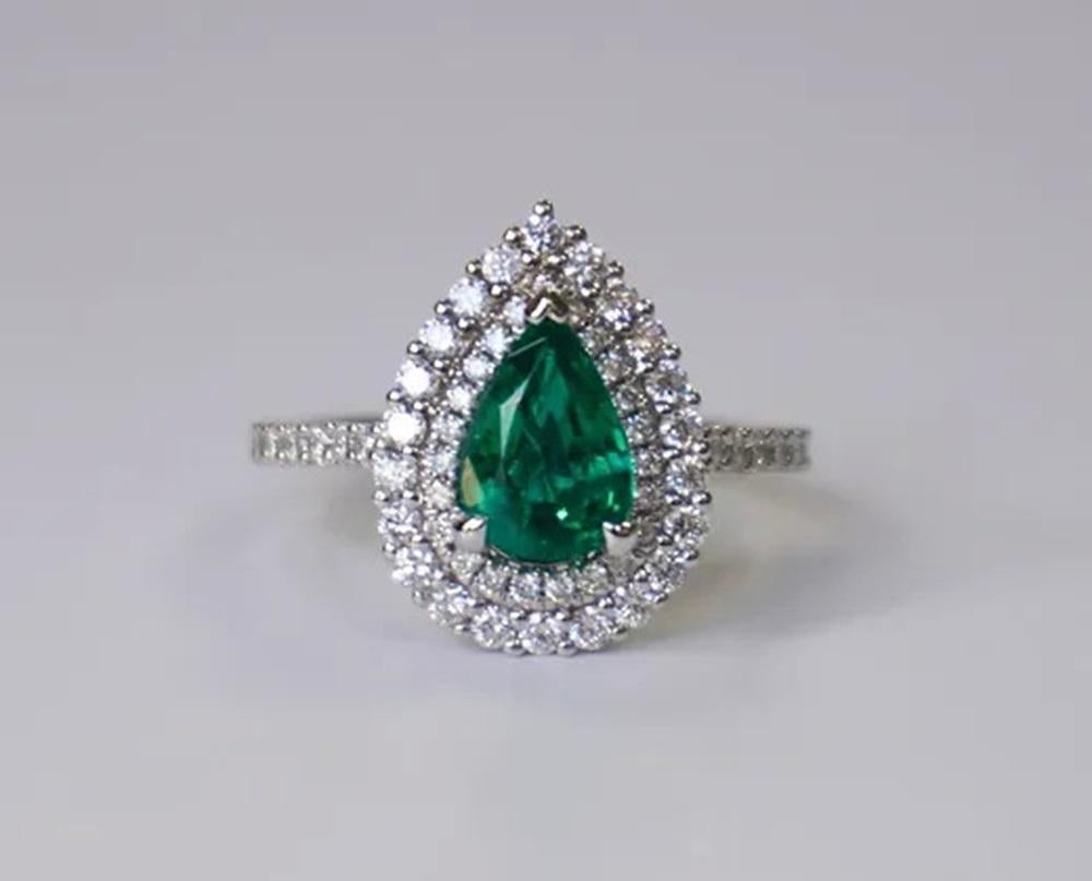 Emerald Weight: 1.19 ct, Measurements: 9x6 mm, Diamond Weight: 0.77 ct, Metal: 18K White Gold, Metal Weight: 4.74 gm, Ring Size: 6.5, Shape: Pear, Color: Vivid Green, Hardness: 7.5-8, Birthstone: May, Origin: Zambia