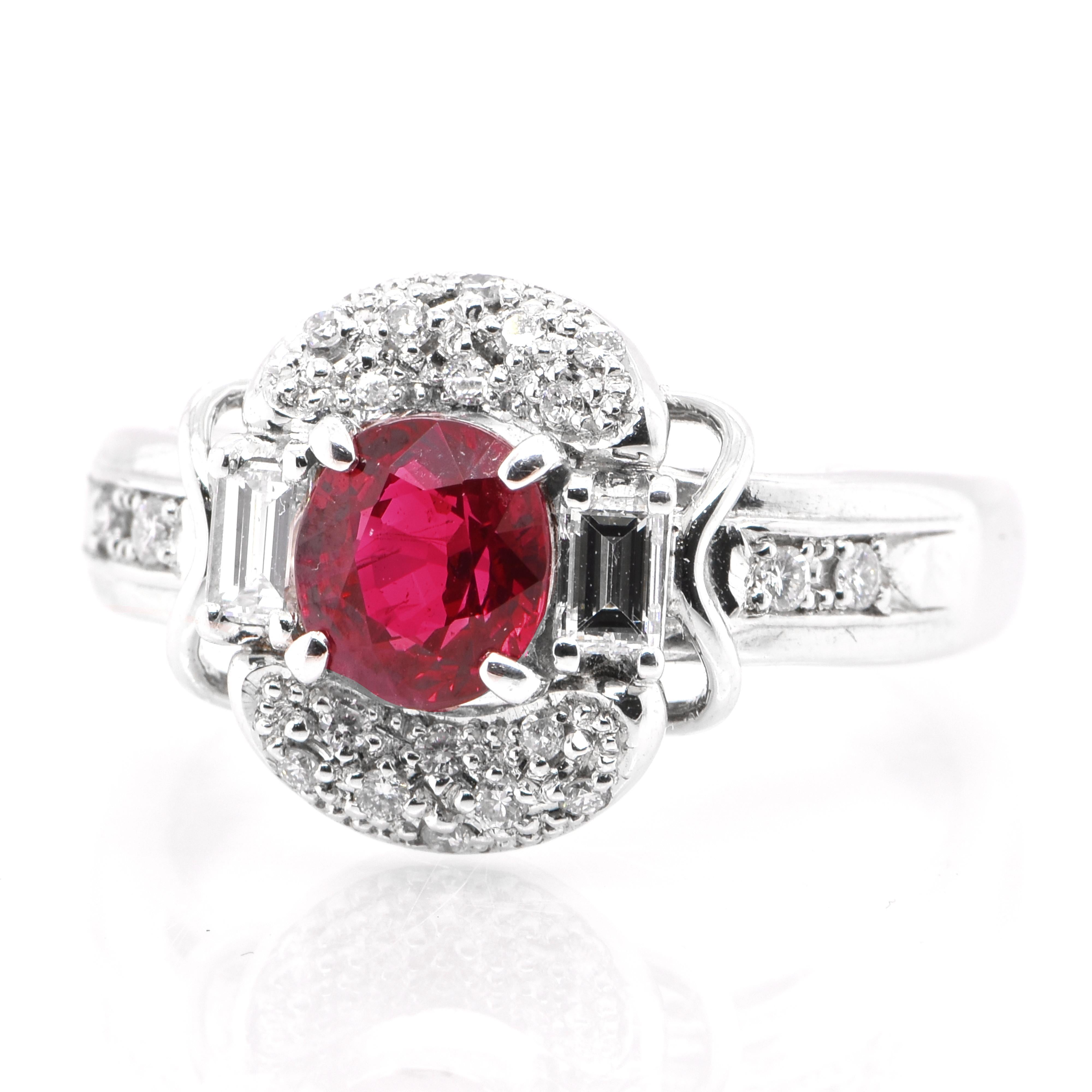 A beautiful Engagement Ring featuring a 1.19 Carat, Natural, Vivid-Red Ruby and 0.40 Carats Diamond Accents set in Platinum. The Ruby displays really exceptional luster and color. Rubies are referred to as 
