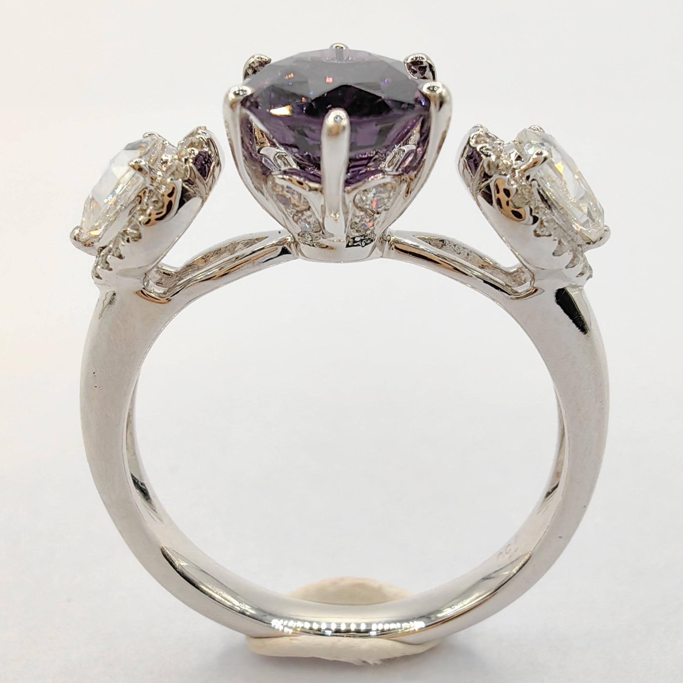 Introducing our exquisite 1.19 Carat Oval Cut Purple Spinel Rose Cut Halo Diamond Ring in 18K White Gold. This remarkable piece showcases a stunning purple spinel as the centerpiece, accompanied by a dazzling array of diamonds.

The main attraction