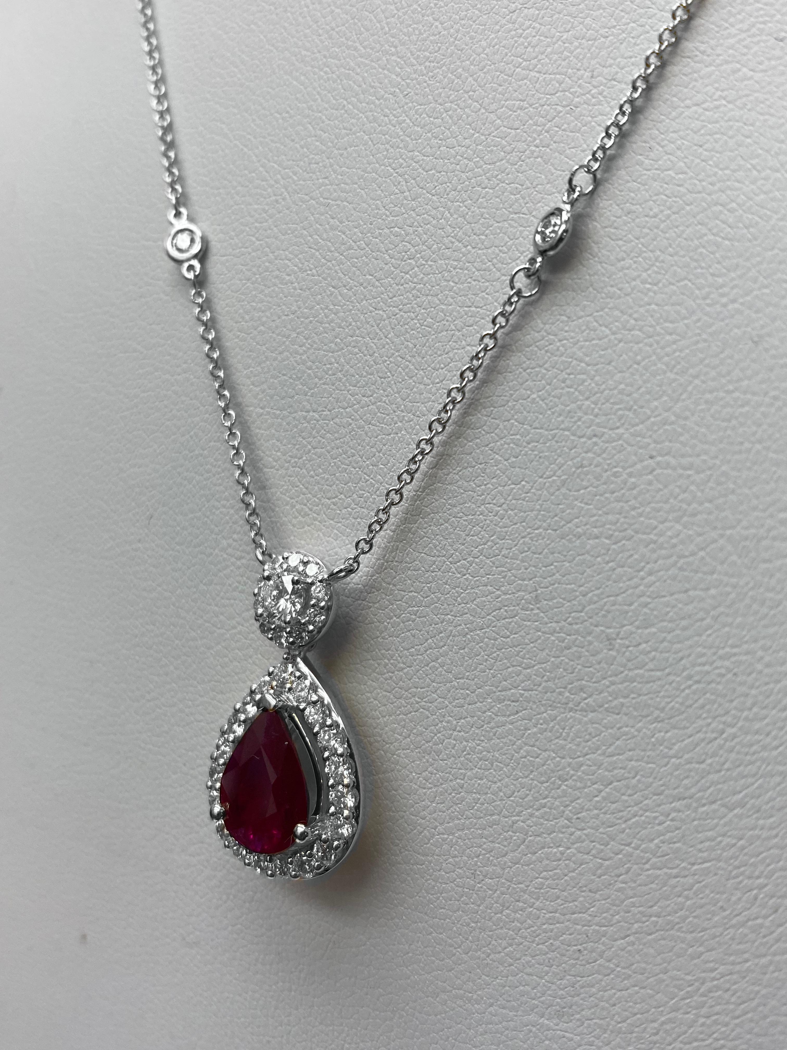Una classica collana con ciondolo che mostra un rubino a forma di pera del peso totale di 1,19 carati. Impreziosito da una fila di diamanti rotondi, per un peso totale di 0,45 carati. Sospeso su un'aureola di diamanti a taglio rotondo attaccata a