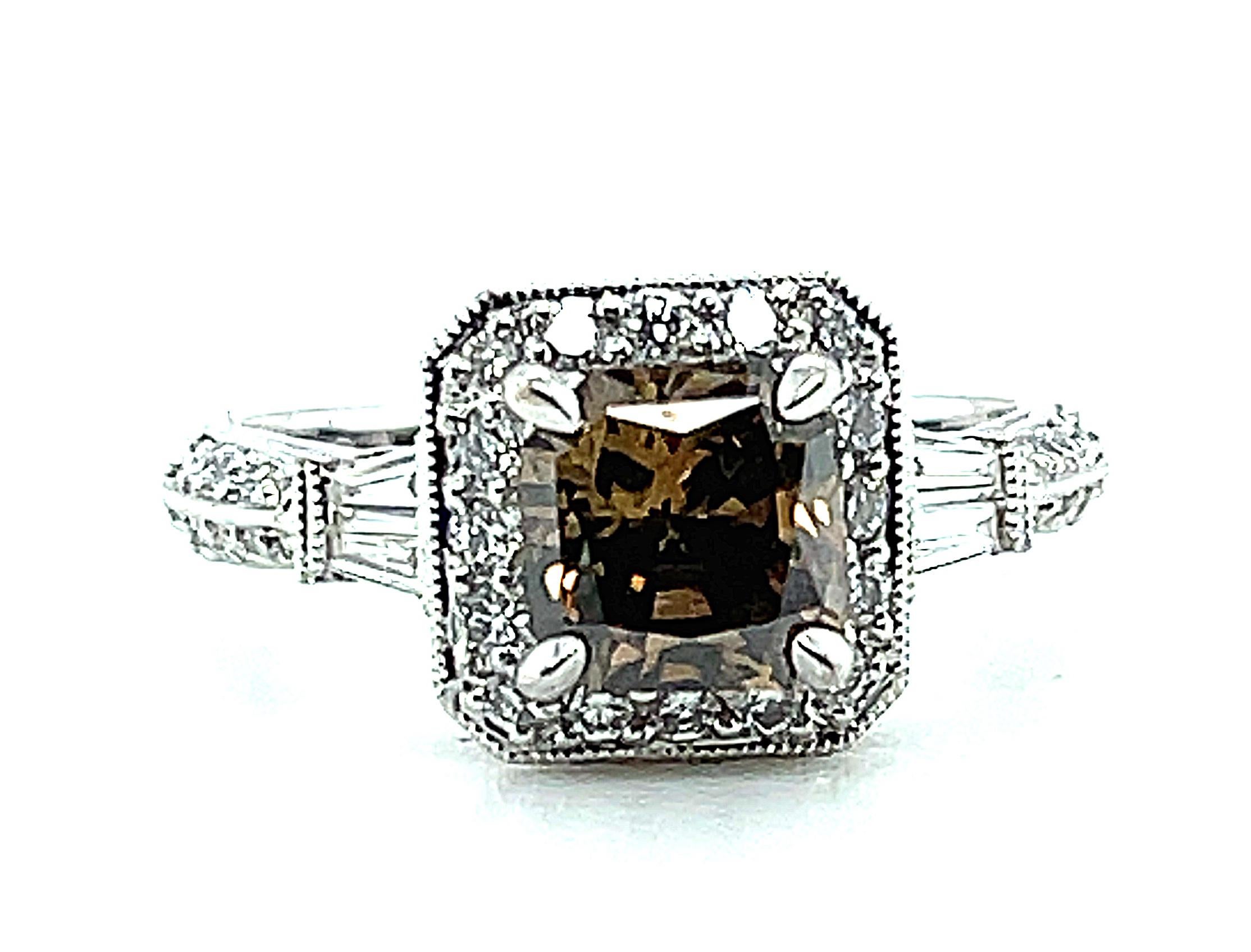 This antique style engagement ring features a brilliant 1.19 carat radiant cut coffee color diamond set in 18k white gold. The dazzling center stone has excellent clarity and life and is surrounded by a halo of sparkling white diamonds. The white
