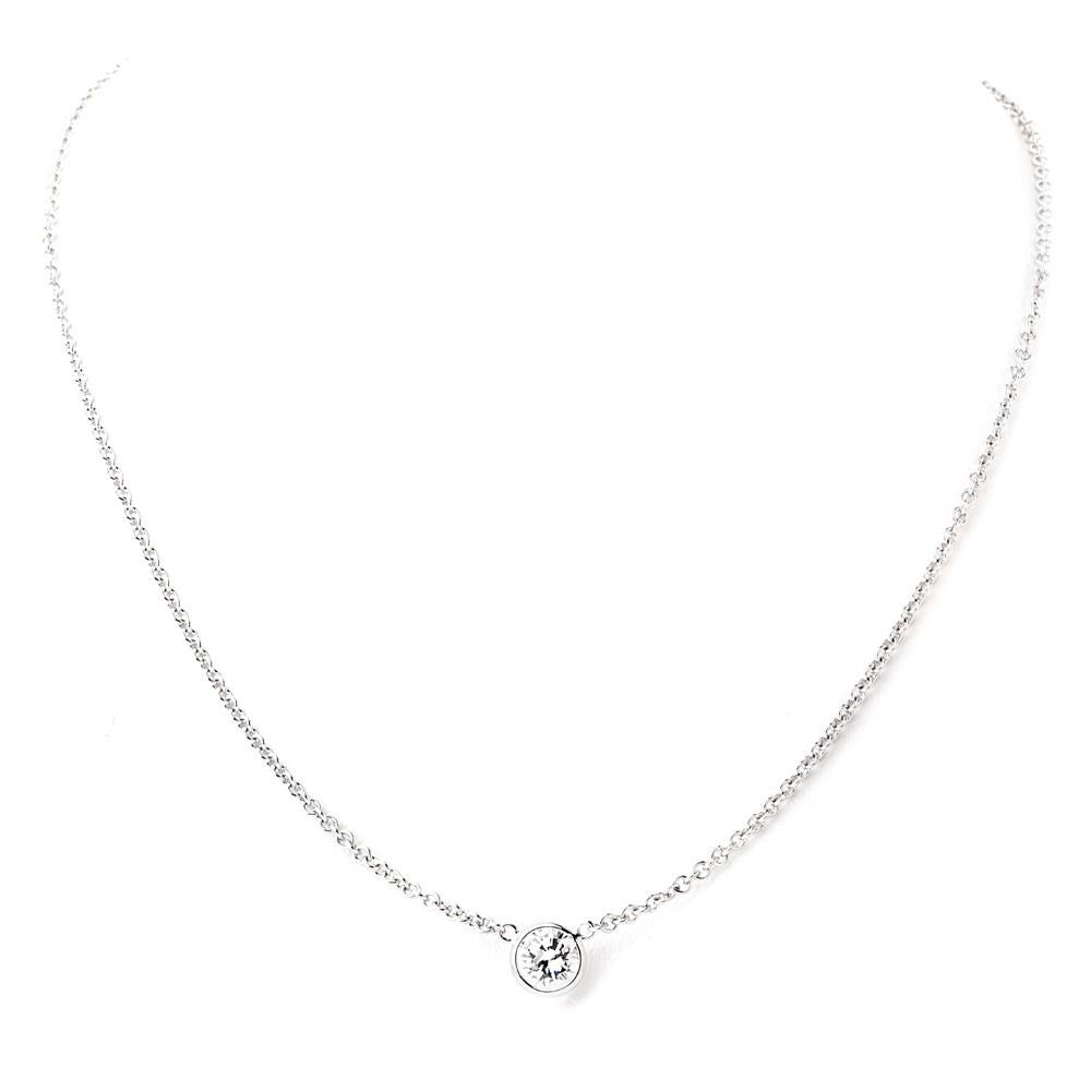 This classic bezel-set diamond solitaire pendant  diamond by yard necklace is crafted in solid 18k white gold.

It is set with one sparkling round brilliant cut diamond approx. 1.19 cartas,

F-G  color, SI2-SI3 clarity (only two white inclusion