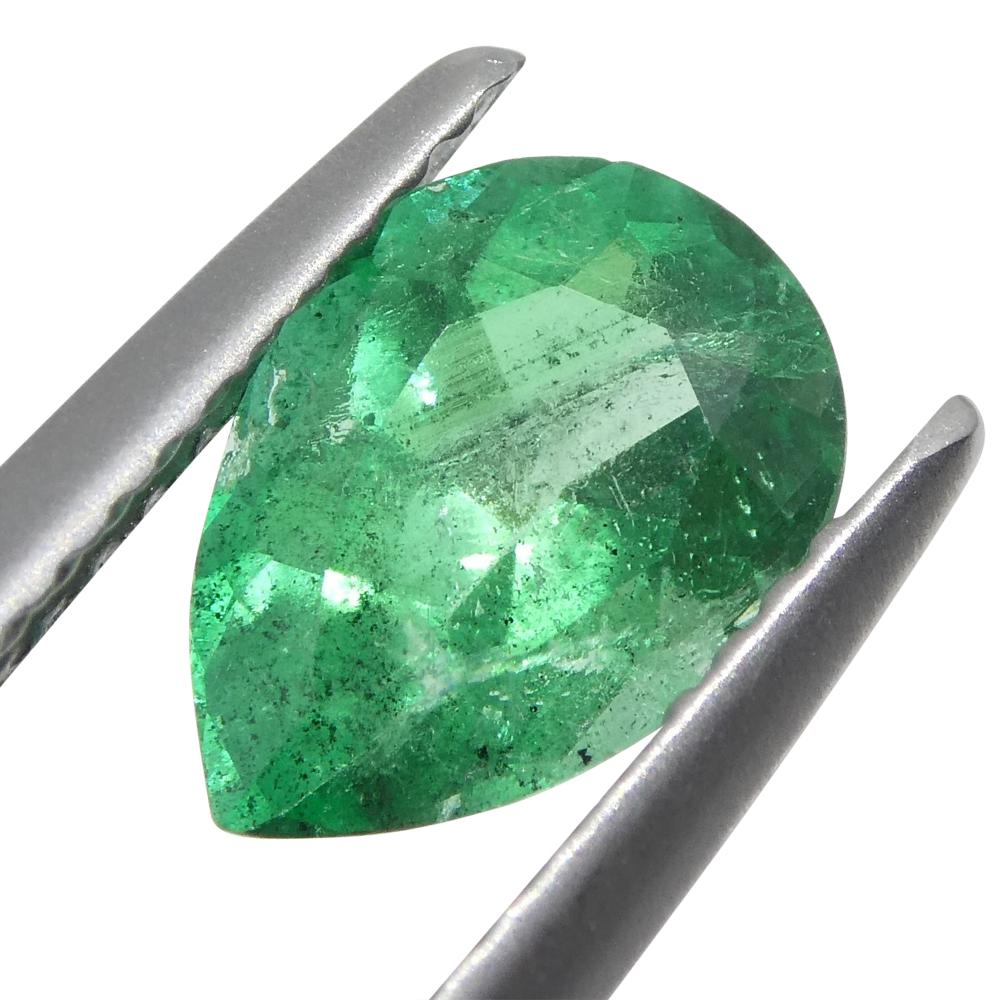 This is a stunning GIA Certified Emerald 

The GIA report reads as follows:

GIA Report Number: 6204784712
Shape: Pear
Cutting Style: Modified Brilliant Cut
Cutting Style: Crown:  N/A
Cutting Style: Pavilion: N/A
Transparency: Transparent
Color: