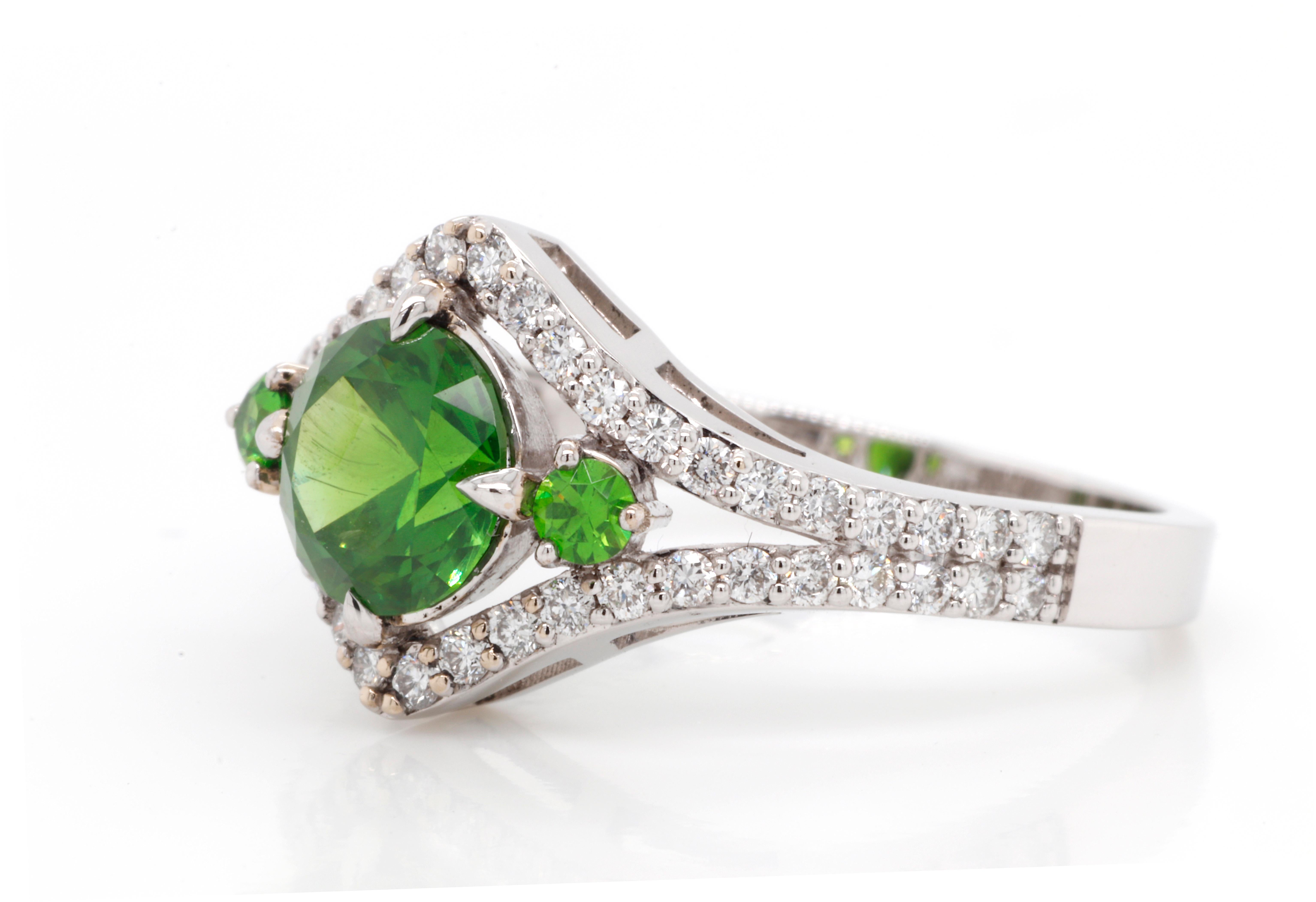 Ellegant 18K White Gold Demantoid Ring with Diamonds. Featuring 1.19 ct of top quality Russian Demantoid combined with natural 0.36 ctw Diamonds G-H color and VVS1 clarity. 
Demantoid is a unique rare stone, called a star of garnets, origin is from