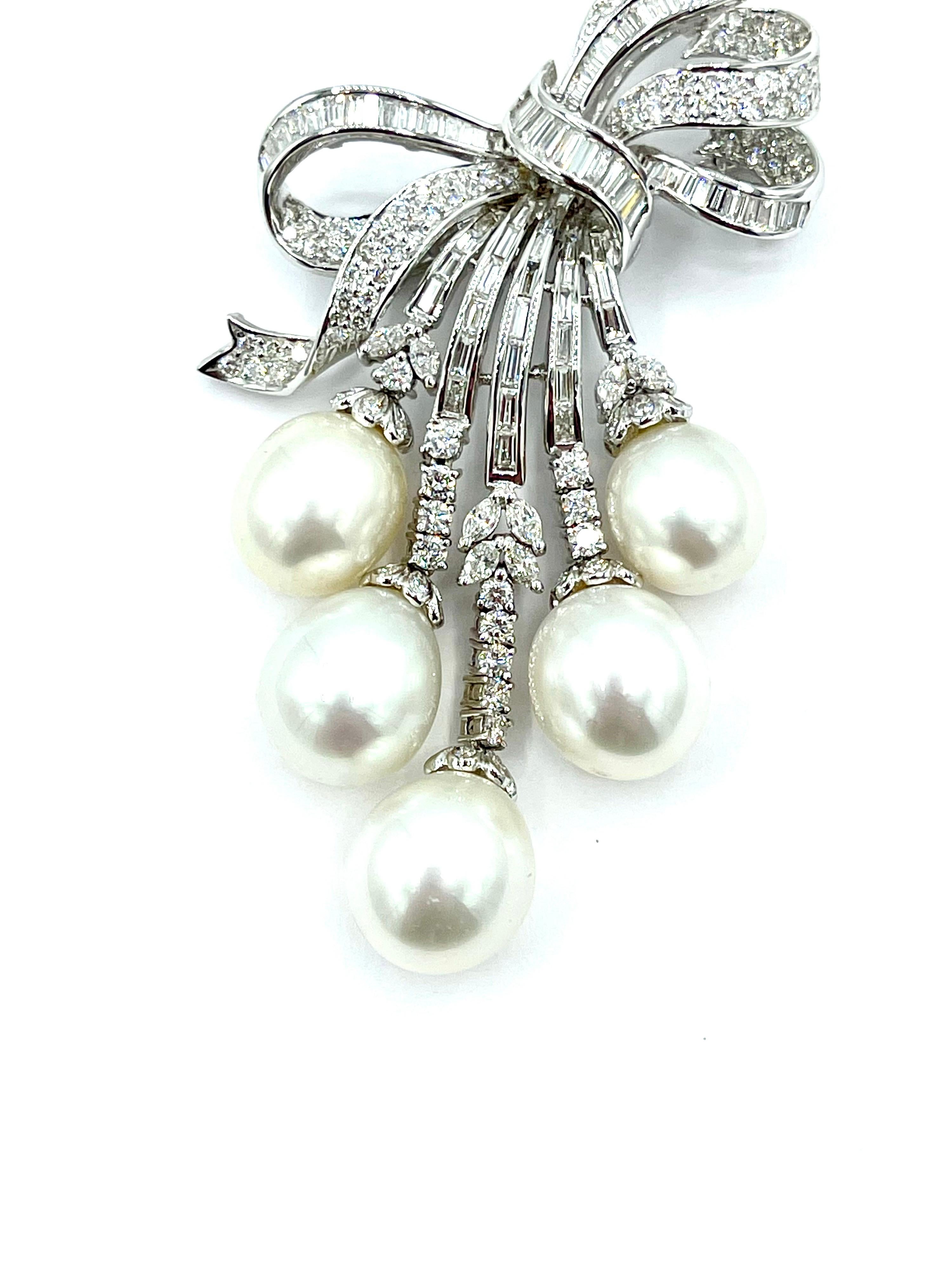 A gorgeous pendant and brooch literally dripping with Diamonds and Pearls!  There are five South Sea Pearls graduating in size from 11.90 to 13.80mm,  suspended from extensions of the main bow, all set with round brilliant, marquise, and baguette