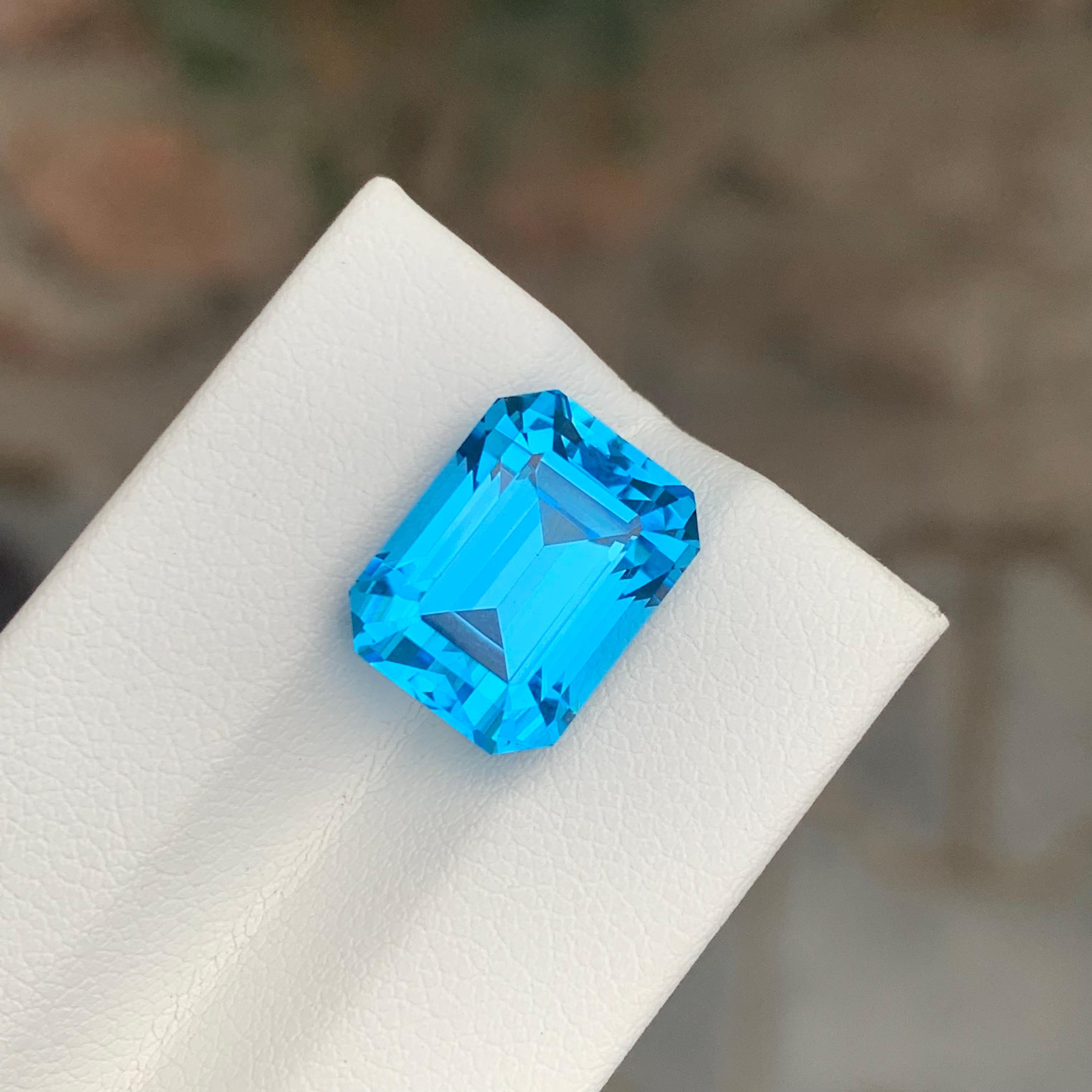 Women's or Men's 11.90 Carat Excellent Loose Swiss Blue Topaz Emerald Shape Gemstone For Sale