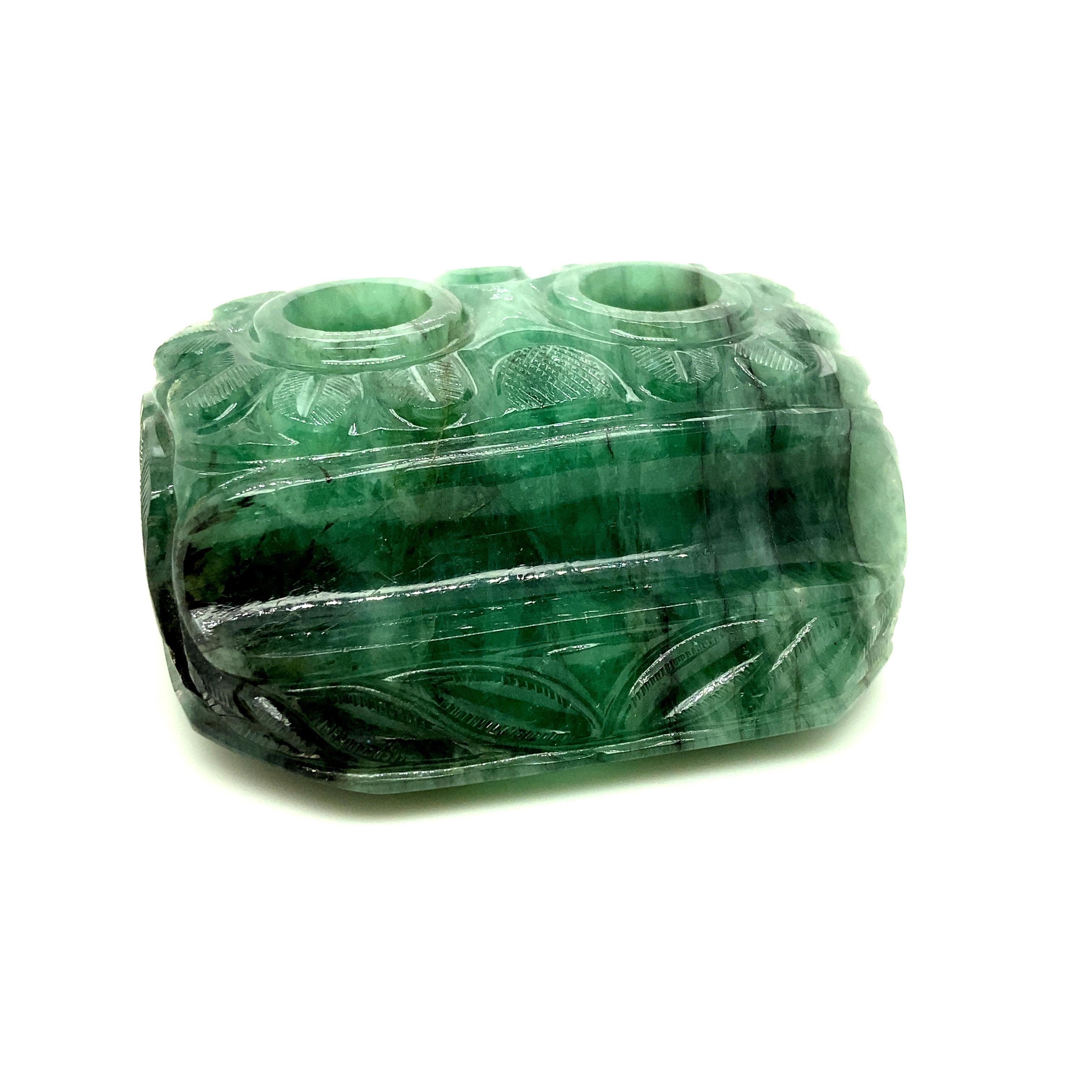 1191 Carat Carved Emerald Pen Holder: 

An incredibly rare and fascinating piece, it is an antique carved emerald pen holder weighing an enormous 1191 carats in total. This is truly a one of a kind carved emerald piece. The emerald is completely