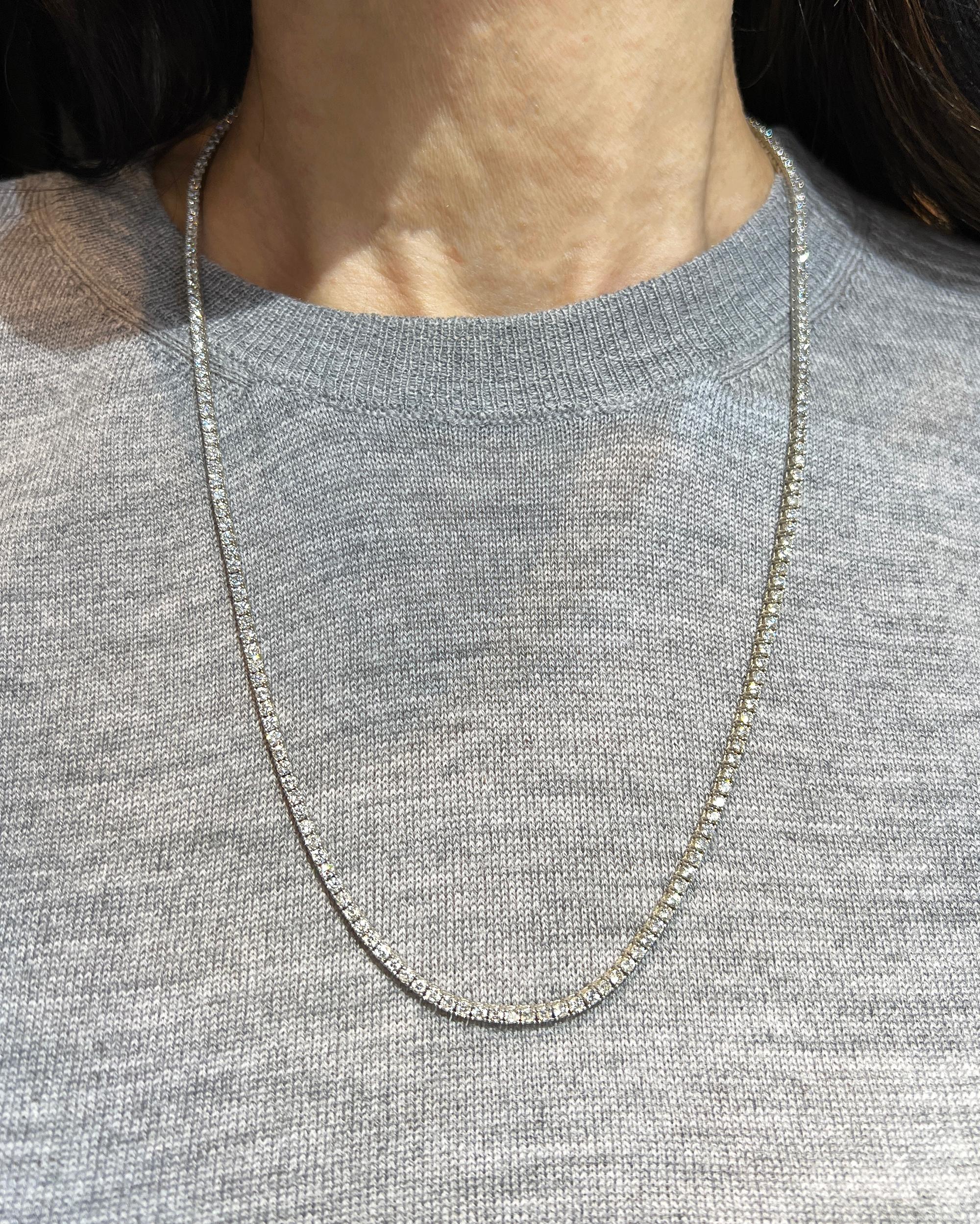 Timeless tennis necklace comprising of round diamonds weighing 11.94 carats total.
Carat weight of each diamond is 0.05.
The diamonds are not certified and estimated as G-H colors, VS-SI clarity.
Metal is 14k white gold. Weight is 20.99 grams. 
The
