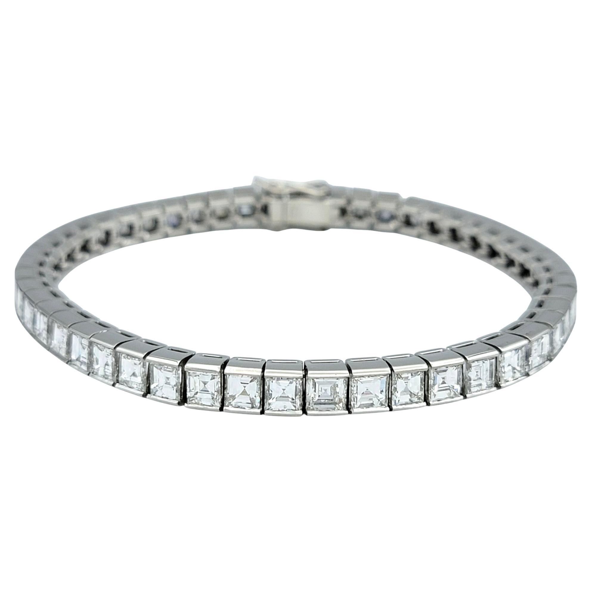 Indulge in timeless luxury with this exquisite platinum diamond tennis bracelet, a breathtaking expression of elegance and sophistication. Designed with forty-nine square step-cut diamonds, this bracelet radiates brilliance with its sleek, modern