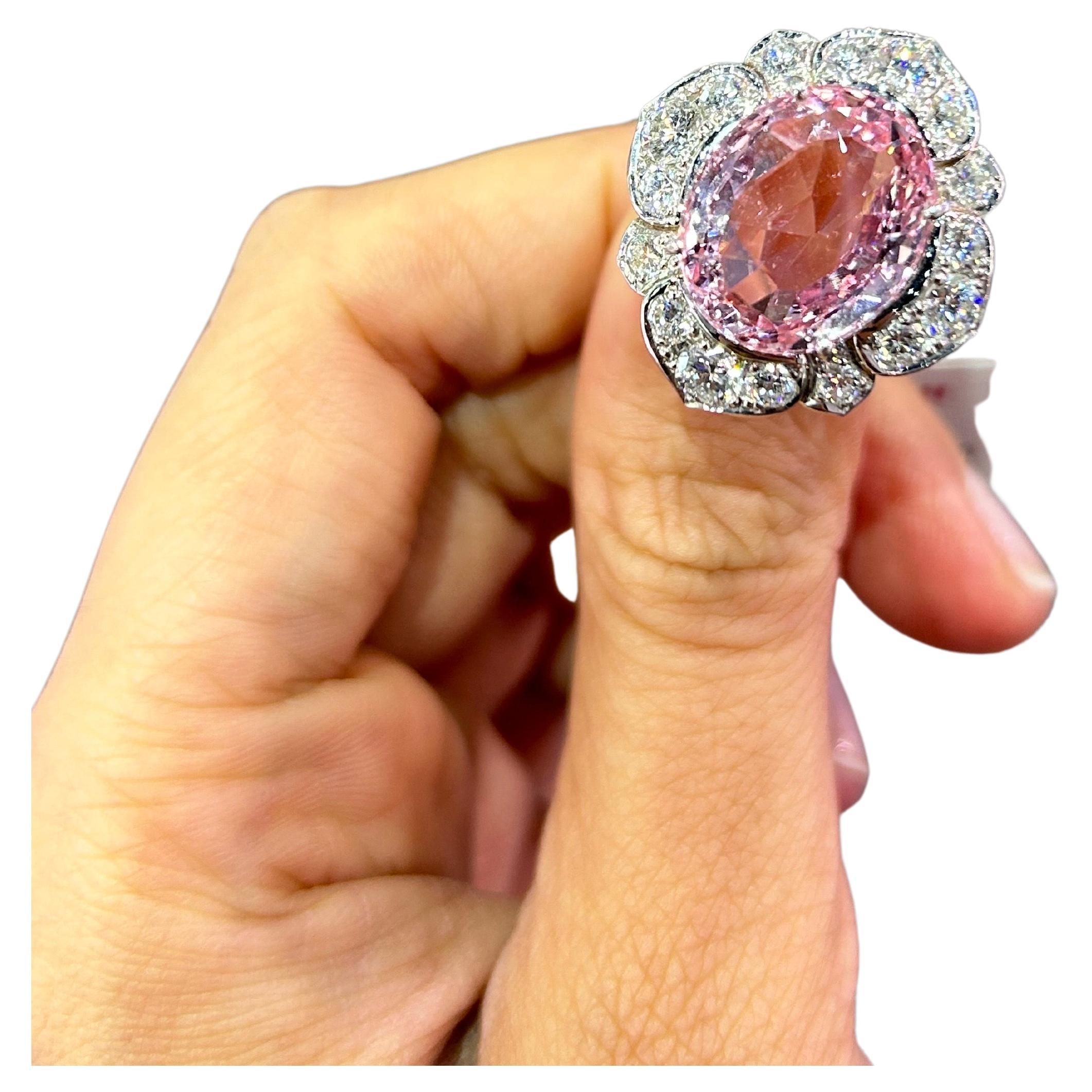 A one of a kind, natural oval shaped Padparadscha Sapphire cocktail ring, set elegantly with Diamonds. It is truly a collectors piece, as Padparadscha Sapphire are a rare find, especially of this large size. The ring is currently sized at US7, can