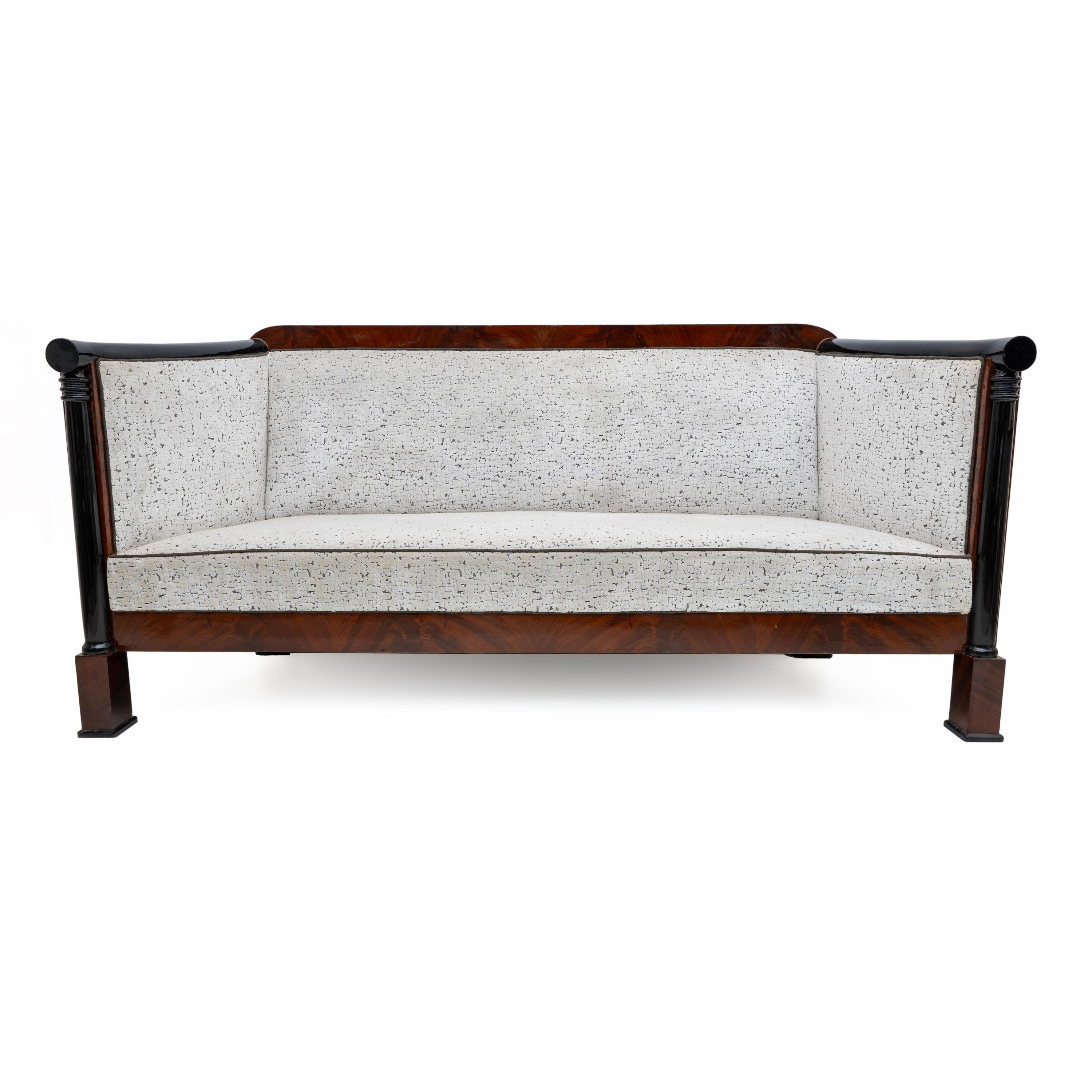 This elegant and truly exceptional Viennese Biedermeier-style sofa was made around 1840.

Made of mahogany and ebonized beech veneer, polished to maintain the original period patina, it is upholstered in textured ivory white velvet. The sofa is