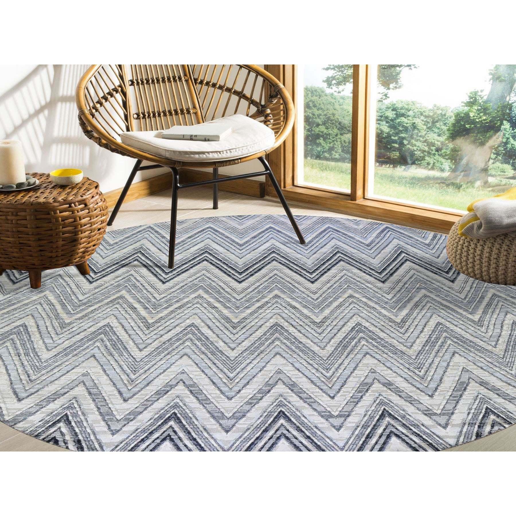 This is a truly genuine one-of-a-kind Gray-Blue Chevron Design Textured Wool and Pure Silk Hand Knotted Round Oriental Rug. It has been woven for months and months in the centuries-old Persian weaving craftsmanship techniques by expert